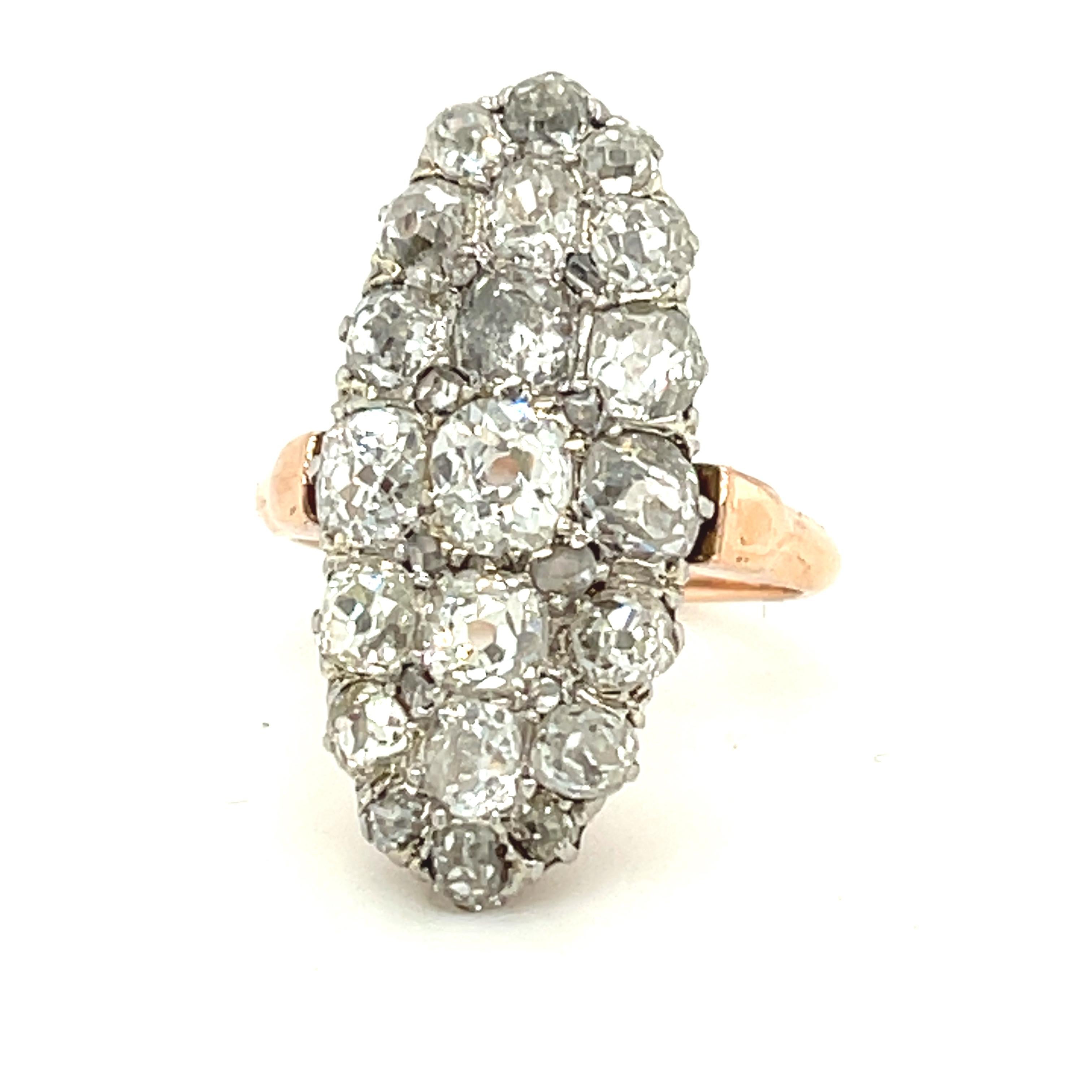 A charming antique old cut diamond navette shaped cluster ring circa 1880. The ring has an owl French export mark. The ring is made in rose colored 18k gold. The chunky antique cut diamonds weigh about 2.00 carats. They are mostly I to J color and