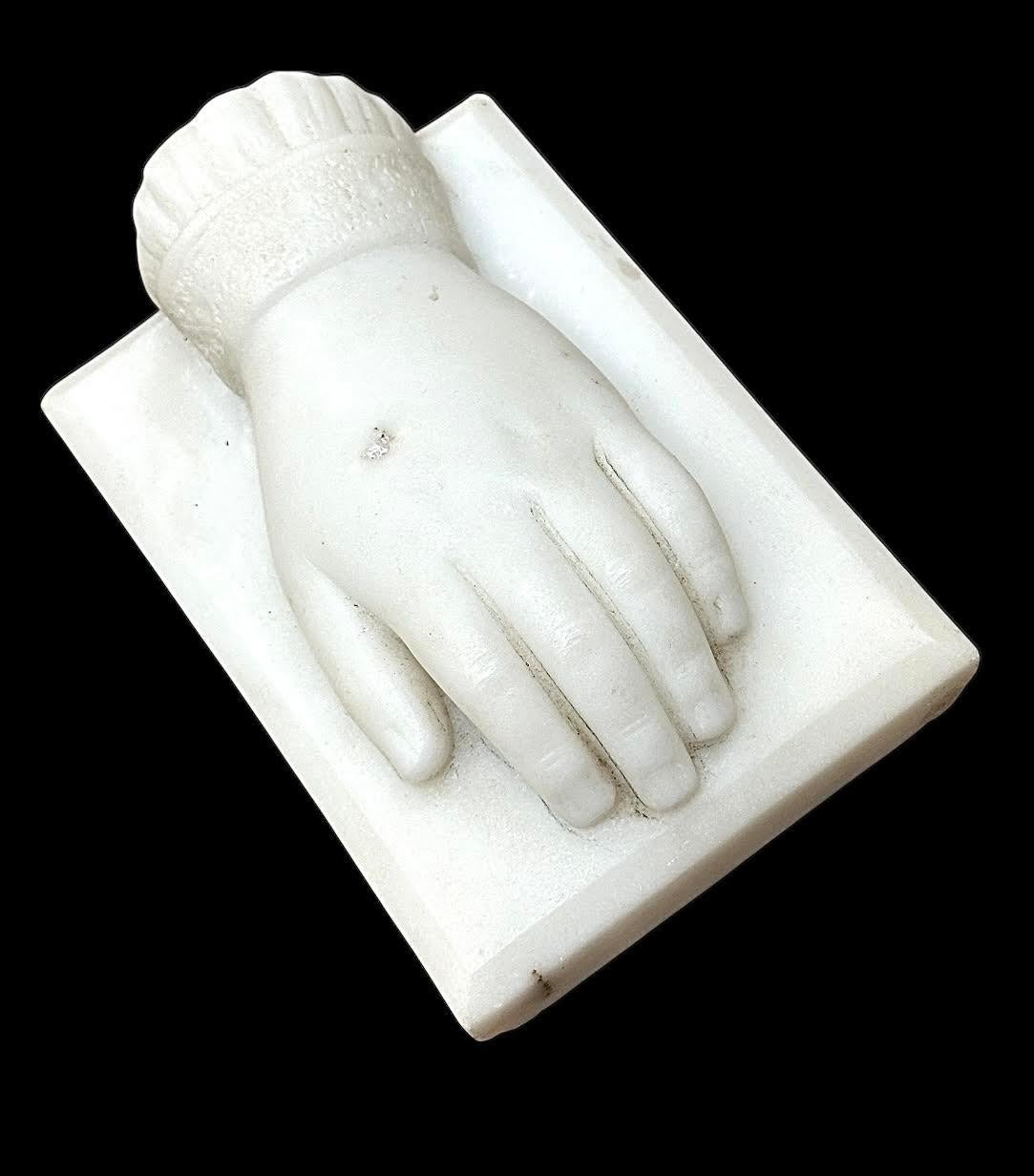 Late 19th century French carved marble rendition of a hand with a decorative cuff. Most likely a child's. Original untouched surface. Beveled edges. Only very minor chips to the bottom corners. Lines around fingers appear to be pencil marks and are