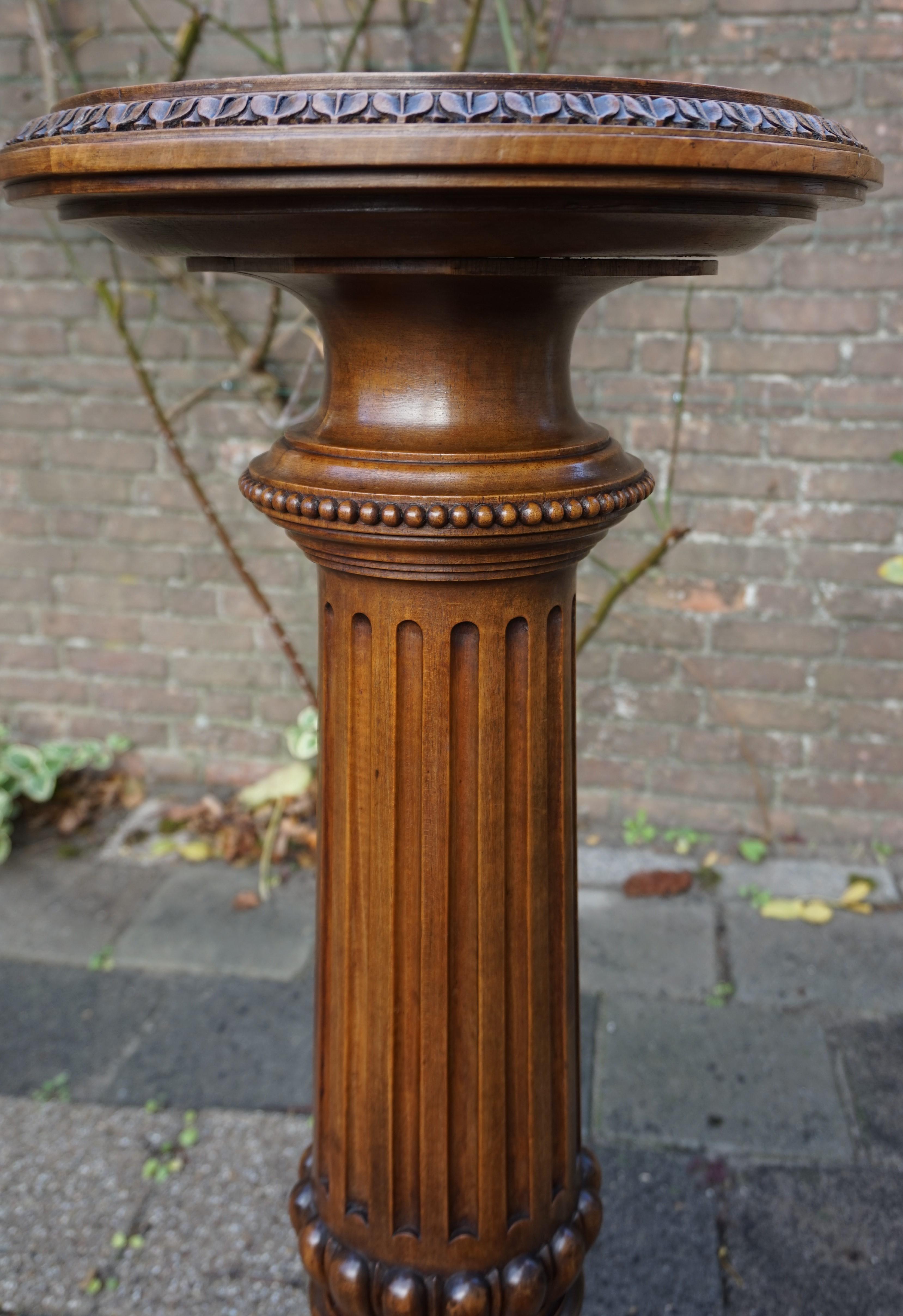 Stunning classical style display column with warm patina.

This marvelous piece of late 19th century workmanship is another fine example of the quality that was made in those days. All hand-crafted out of solid walnut and beautifully patinated from