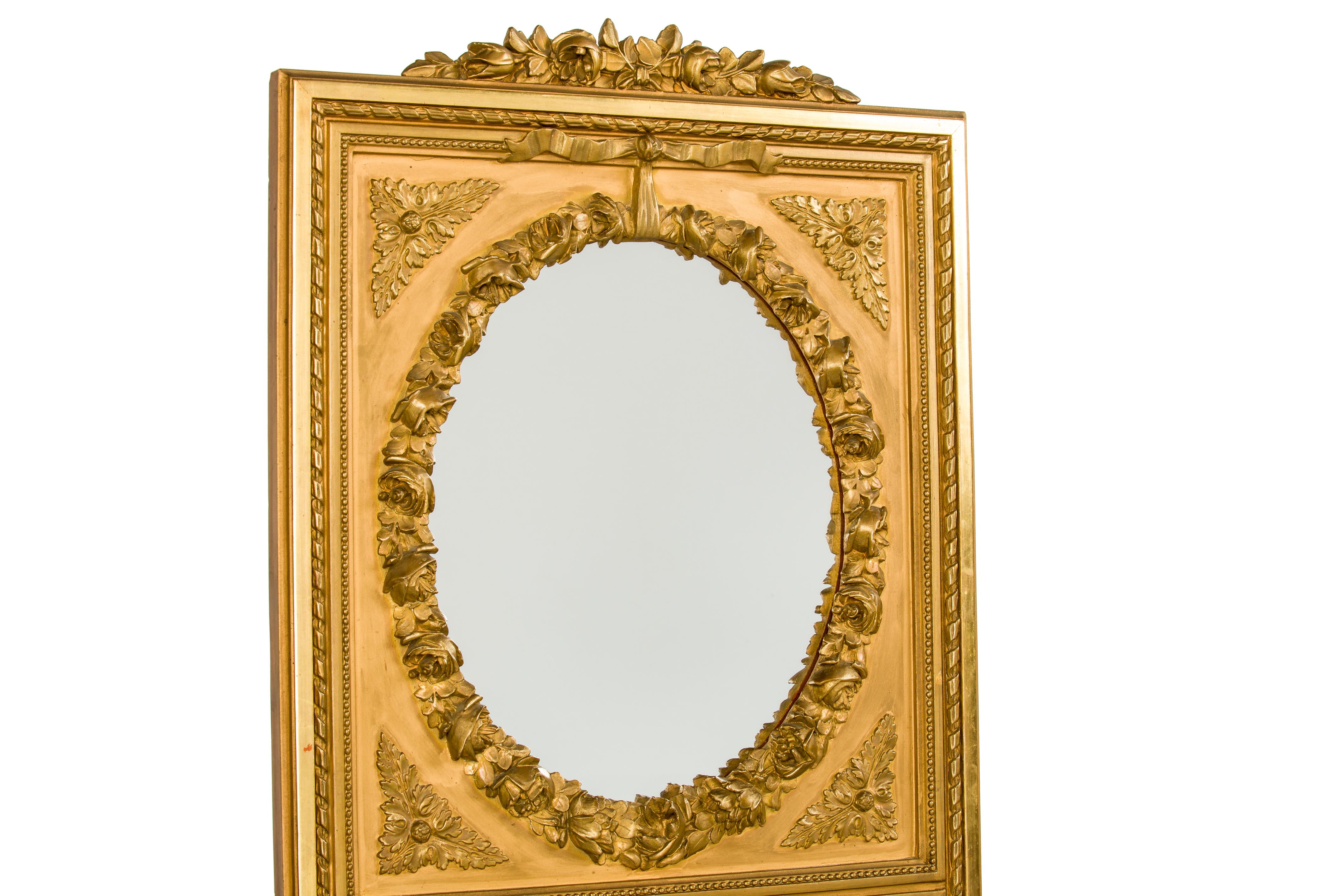 A very handsome and tall pier mirror that was made in the late 19th century in Northern France. Its square frame, decorative borders, and crest are typical for the Louis Seize style. The modest crest features beautiful roses with leaves. Below is a
