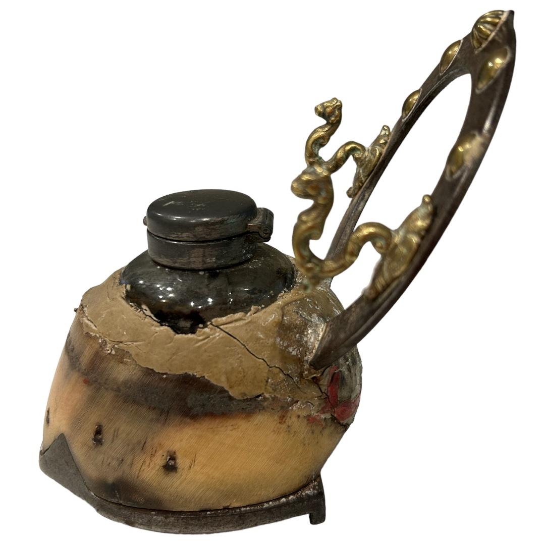 Antique mounted horse hoof made into an inkwell with a pen holder from a horseshoe; these were popular in the 19th century to transform hooves into inkwells as a simple way to remember their beloved animal. This hoof is decorated with a horse shoe