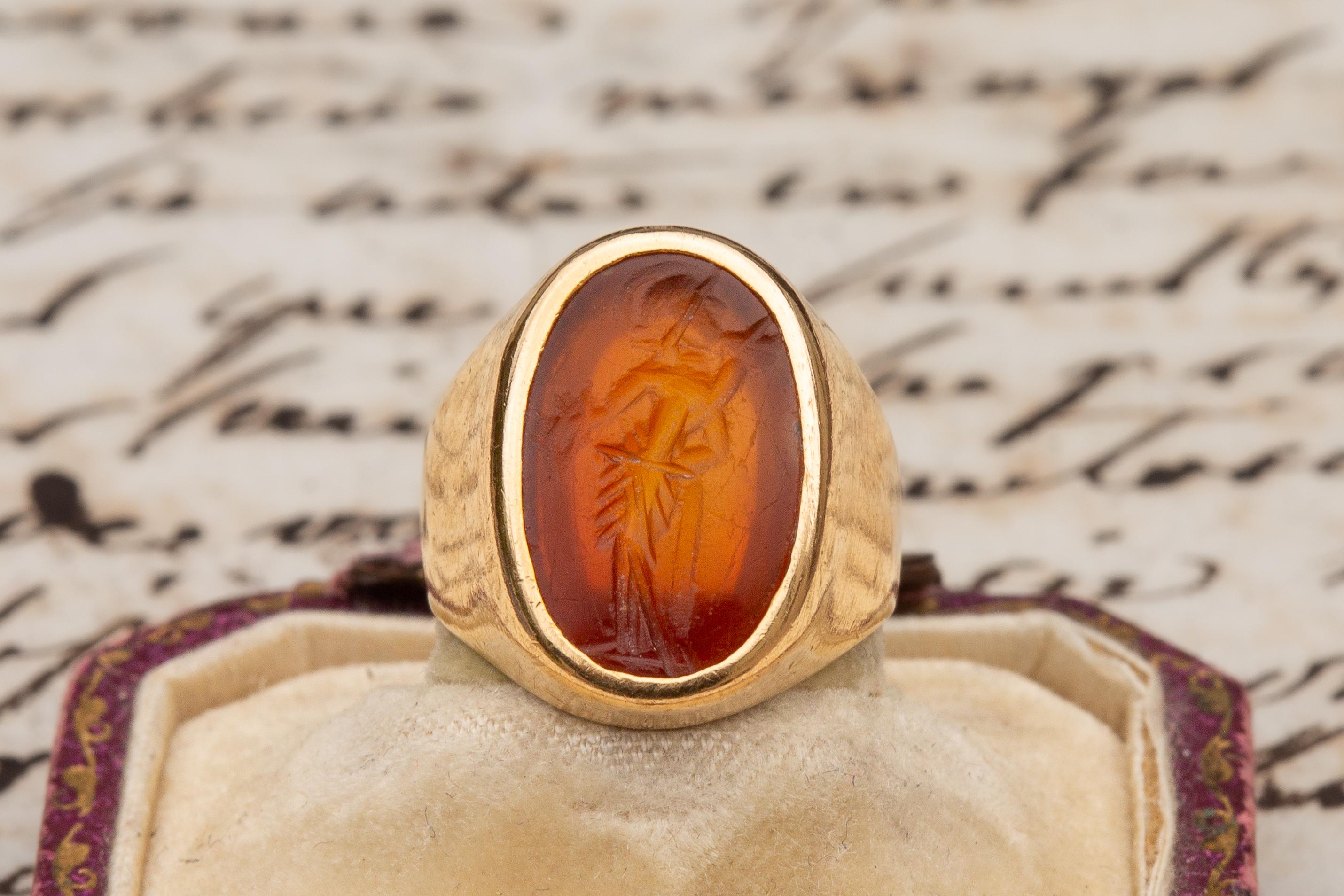 A superb late 19th century (c.1890) French gold signet ring set with an Ancient Roman intaglio. The carnelian gemstone is crudely engraved and dates to the 1st-3rd century AD.  It is typical of Romano-British intaglios and depicts Fortuna, the Roman