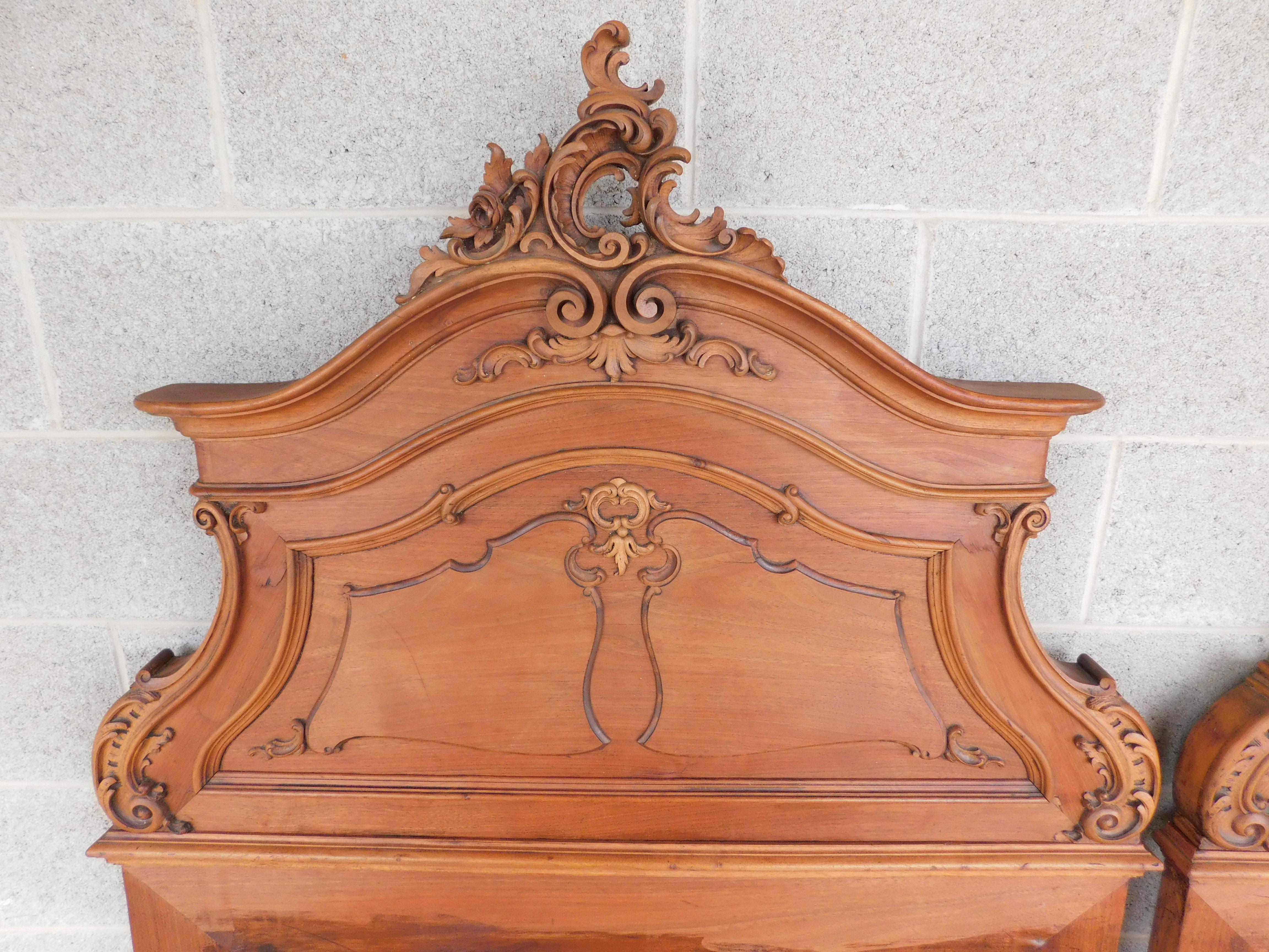 Antique Late 19th Century Walnut French Rococo Carved Twin Headboards - a Pair

Fine detailed rococo carved leaf and rose motif top center to the headboard, carried down to the center book matched layered panel of carved designs ( lower cross