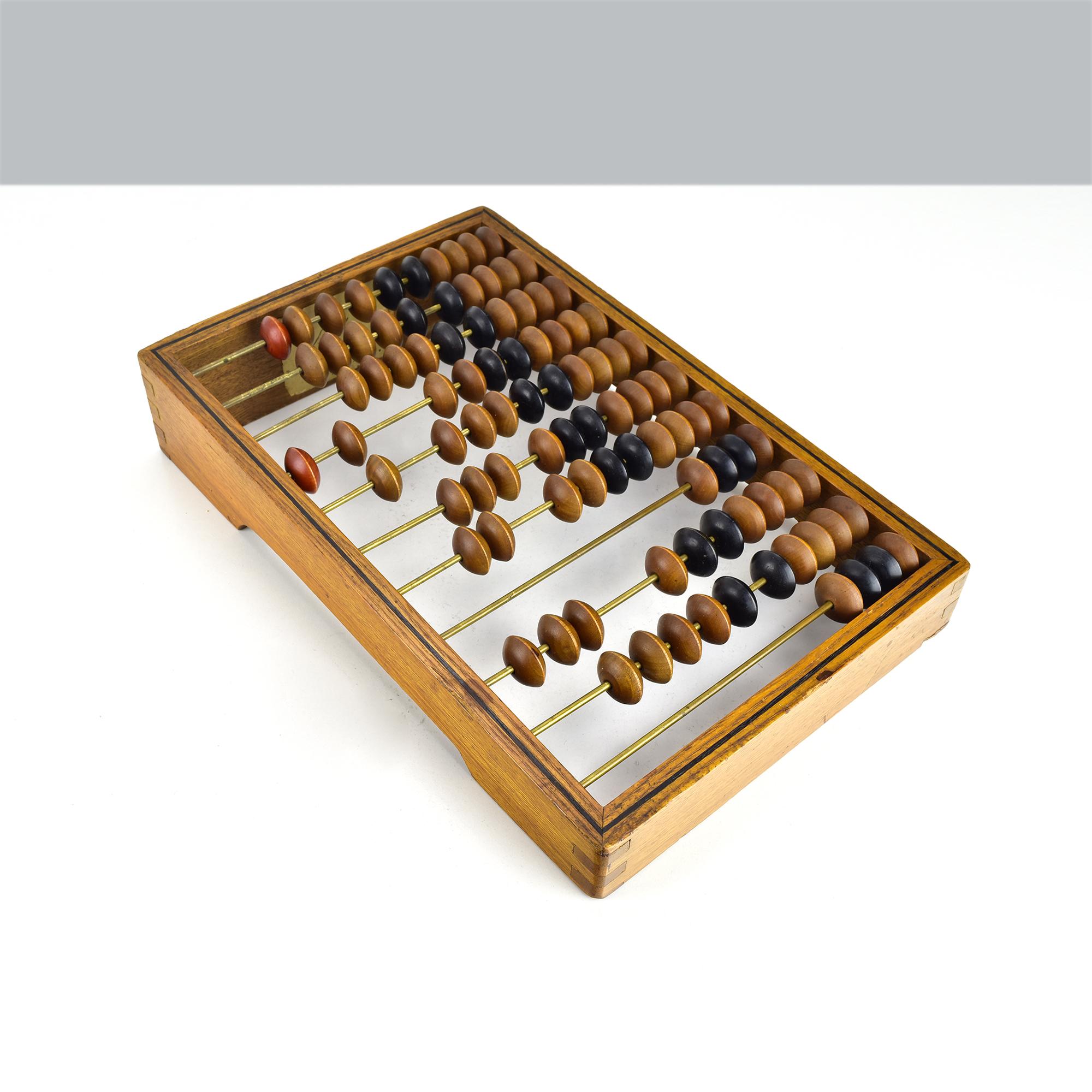 This antique late 19th-century wooden abacus is a timeless tool of calculation, showcasing beautifully crafted natural wood beads in alternating shades of brown and black. The frame is constructed from durable wood, with brass rods securing the