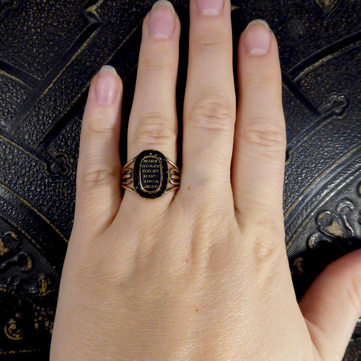 Women's or Men's Antique Late Georgian Mourning Ring with Black Enamel and Garnet Surround Gold