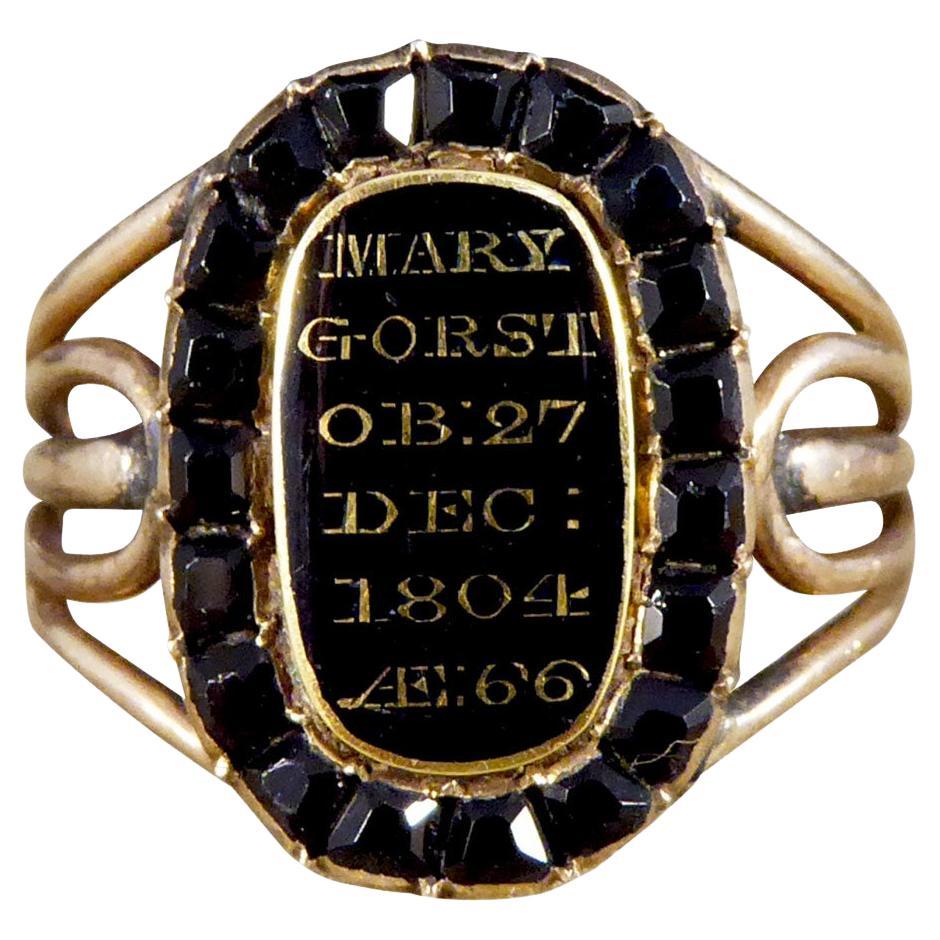 Antique Late Georgian Mourning Ring with Black Enamel and Garnet Surround Gold