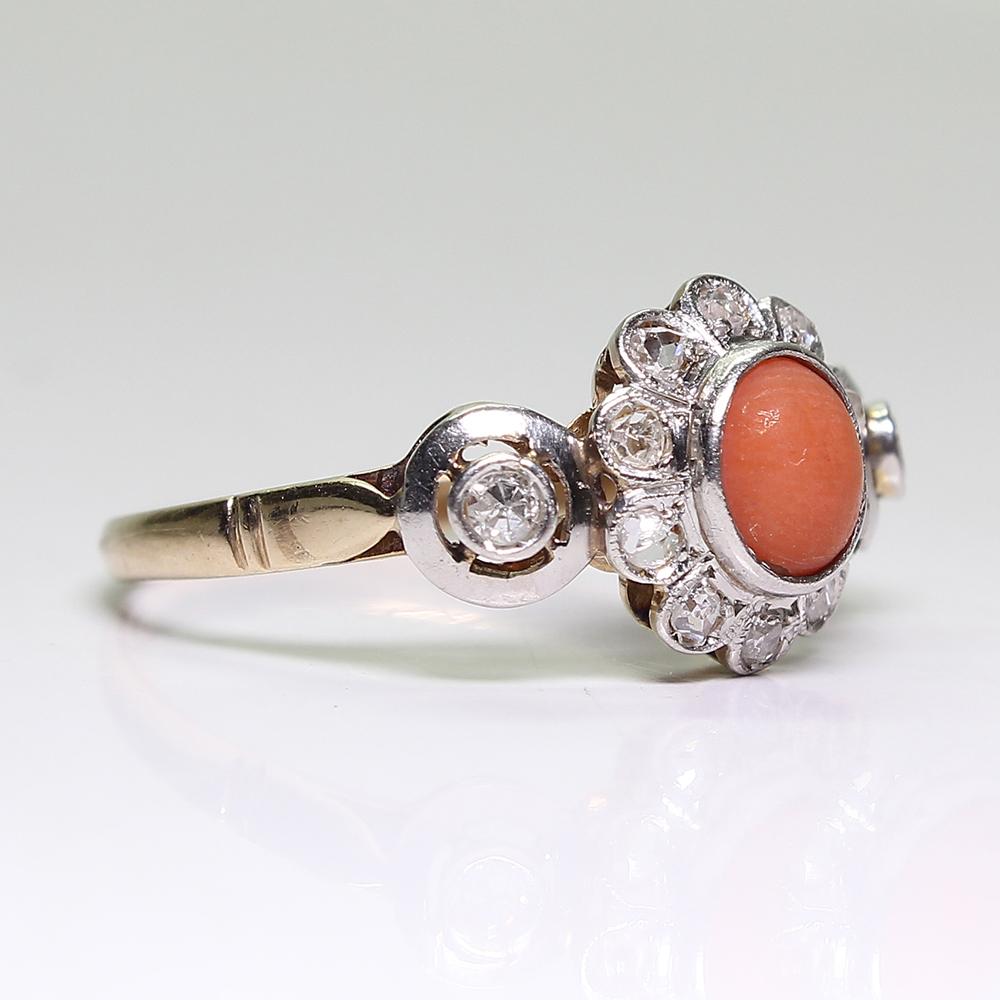 Period: Victorian (1836-1901)
Composition: 18K Gold and platinum.

Stones:
•	1 round cabochon cut coral that measures 5mm.
•	2 Old mine cut diamonds of H-SI1 quality that weigh 0.10ctw.
•	9 Rose cut diamonds of H-VS2 quality that weigh 0.20ctw.
Ring