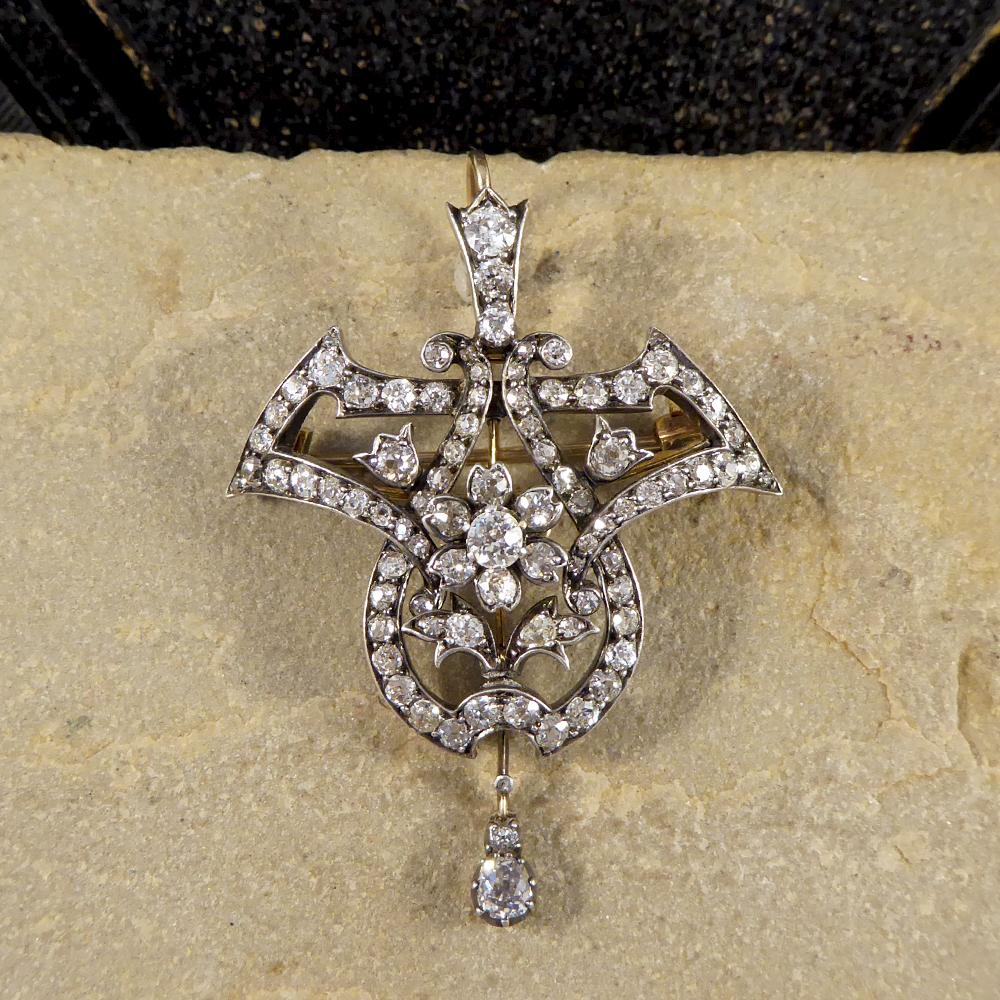 Showing that quality jewellery really does stand the test of time, this gorgeous antique Diamond Pendant/Brooch was hand crafted in the Late Victorian era. In the centre of this piece sits a flower cluster with a full surround of decorative shapes