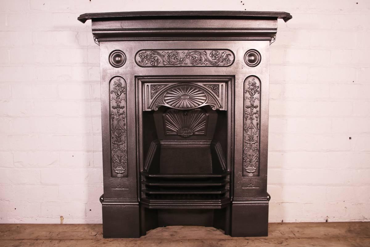 Antique late Victorian cast iron bedroom fireplace. Dated 1899. 

This grate has been finished the traditional black grate polish, leaving a gun metal / pewter shine.

Ready to be installed and used for a real coal or log fire.