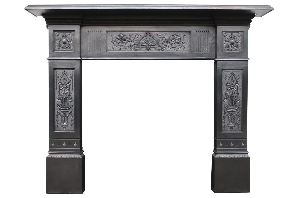 Antique late Victorian cast iron fireplace surround, with finely cast and decorative fielded panels to the jambs, capitals and frieze. Fully restored and finished with traditional black grate polish. Dated 1893. Pictured with an original Victorian