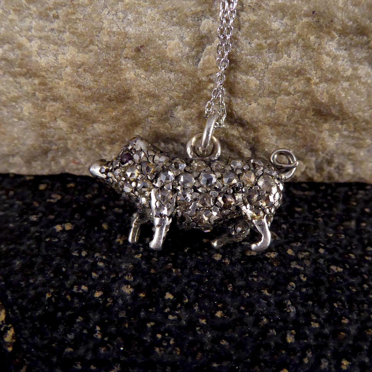 This gorgeous quality and unusual antique pendant depicts a Pig crafted fully from Silver and is fully adorned (front and back) with Rose Cut Diamonds and Rubies for eyes. This Pig was hand crafted with such detail in the Late Victorian era with all