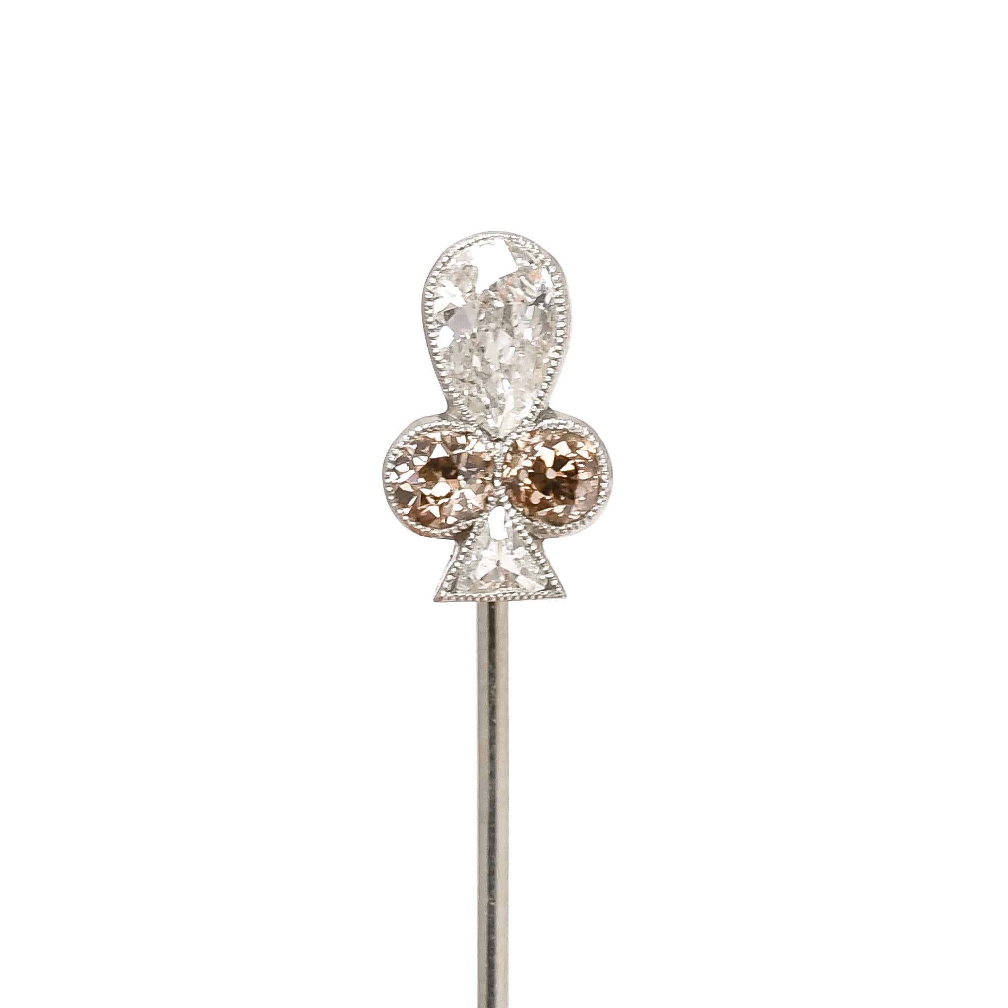 The most incredible antique stick pin with head modelled as the Clubs symbol It dates from the turn of the 20th Century - circa 1900 - crafted in platinum throughout, including the pin, and set with four stunning and unusual diamonds: two cognac old