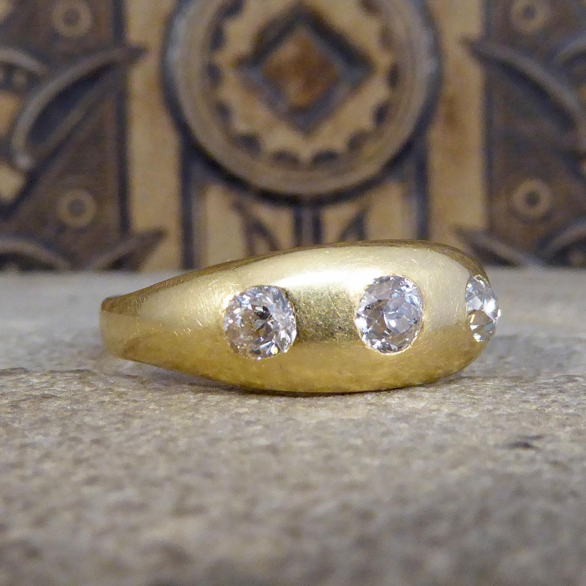 This antique three stone Diamond gypsy ring has been crafted in the Late Victorian and would fit a larger finger size of UK W or US 11. To be worn by either men or women this stunning 18ct yellow Gold gypsy ring features three gorgeous bright Old