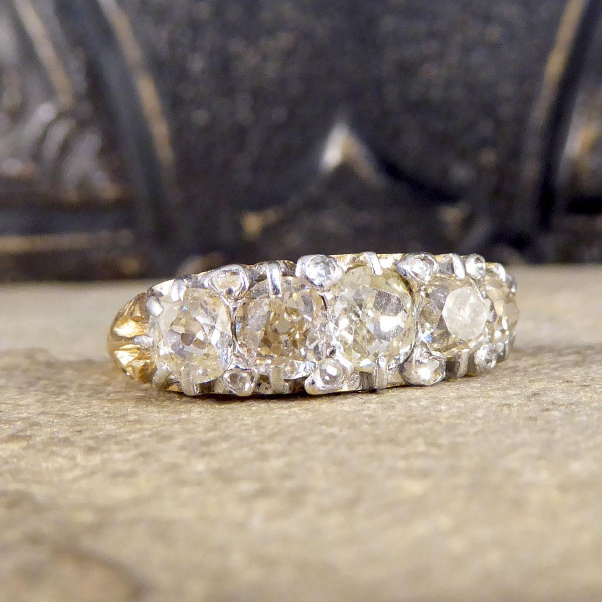 This classic antique five stone ring has been hand crafted in the Late Victorian era in 18ct Yellow Gold with a thick gallery leading to a finer band. The gallery on this ring is astonishing and highlights the quality of the craftsmanship in this