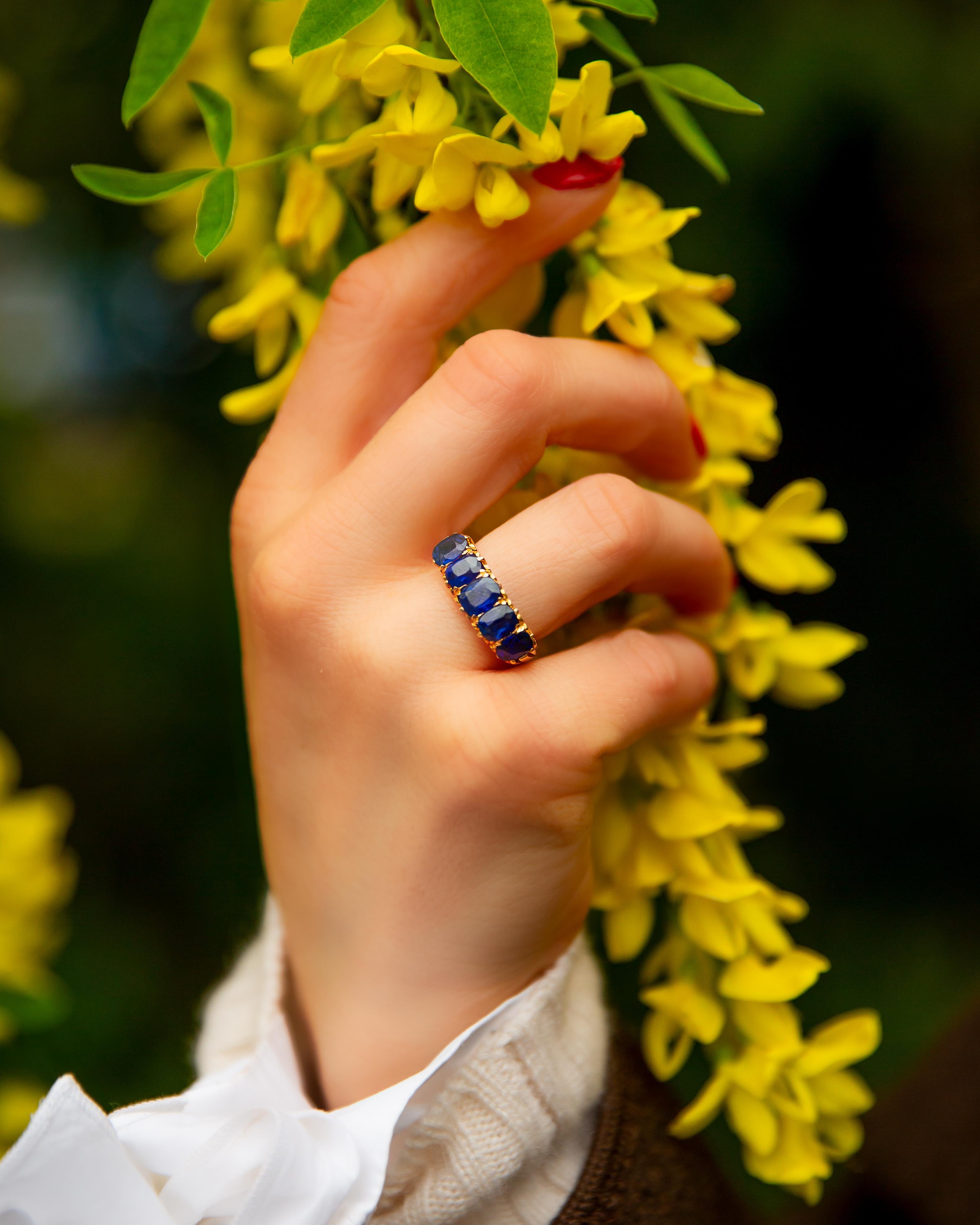 A stunning piece from the Victorian era, this exquisite ring boasts a captivating array of Basaltic blue Sapphires totalling 3.70carats, set in 15kt yellow gold. The intricate multi-claw setting delicately cradles each stone, while the shoulders are