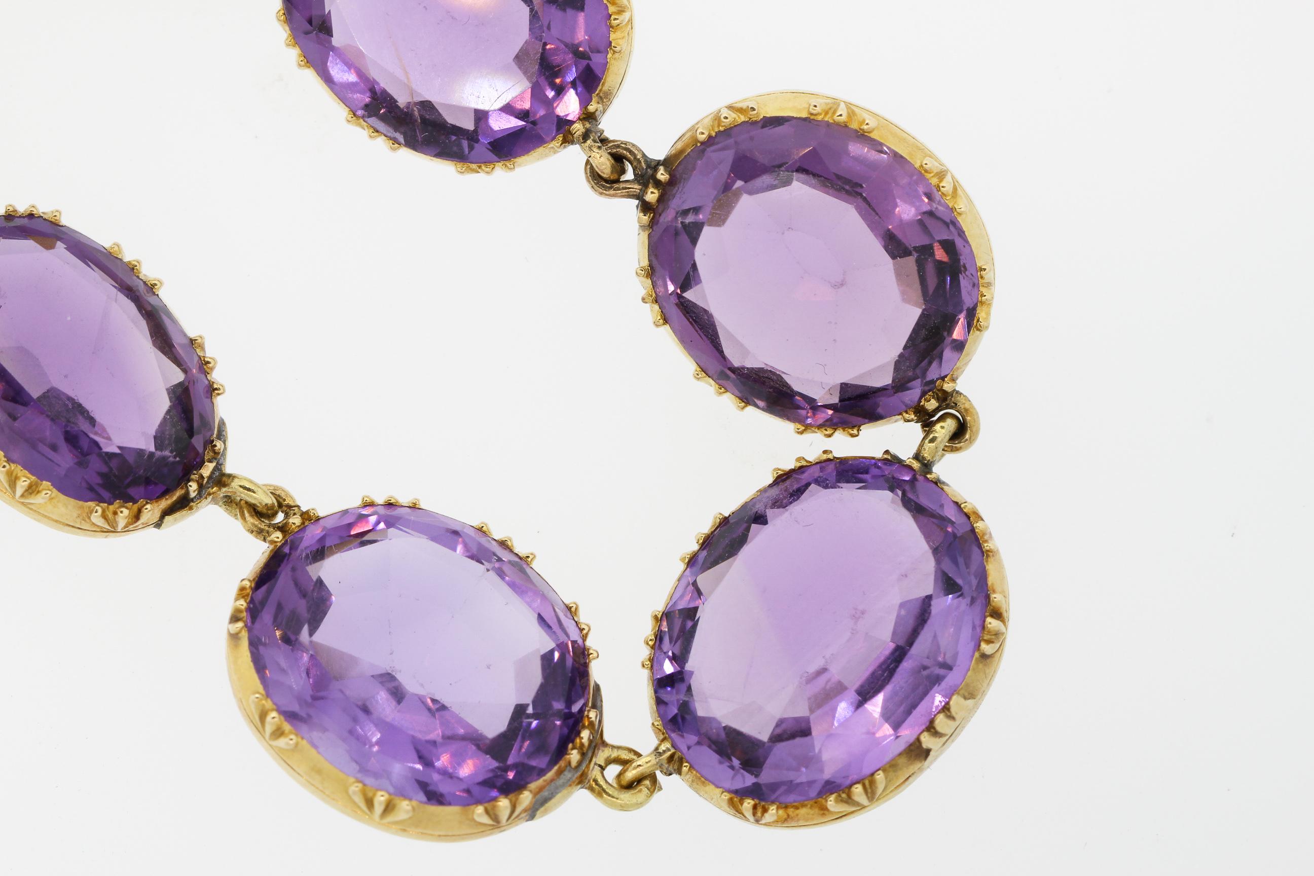 Antique 14k yellow gold collet set amethyst riviere necklace circa 1880. This nicely colored amethyst necklace is open backed, as opposed to the Georgian style closed back necklaces. The oval amethysts are a bright purple color, with depth of color