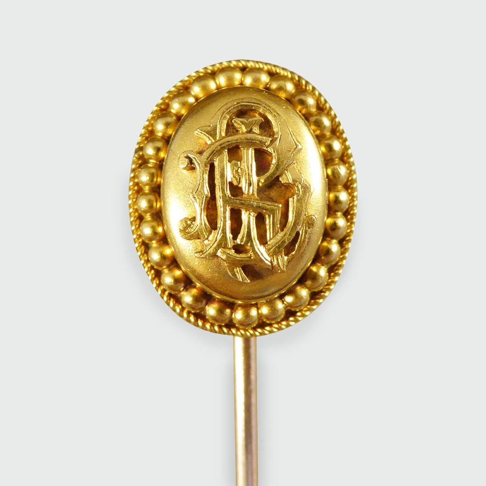 This gorgeous little antique stick pin was hand crafted in the Late Victorian era. It is unmarked high carat Gold but the head is believed to be as high as 18ct Yellow Gold. The stick pin shows a monogram of three initials on the head and exquisite