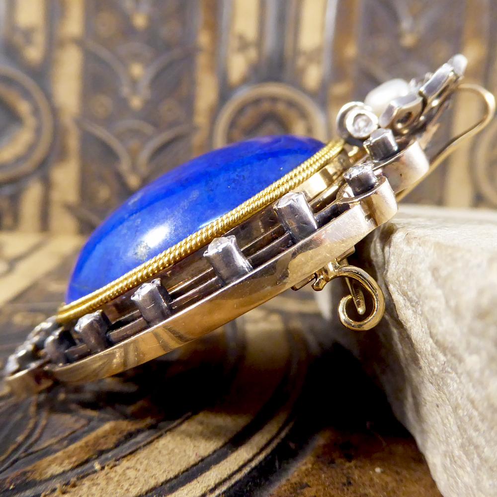 This lovely large Lapis Lazuli Brooch has been created in the Late Victorian era, and although predominantly crafted to be a brooch, it can also be worn as a Pendant. With Rose Cut Diamonds set around the detailed edge of the Brooch and a Pearl sat