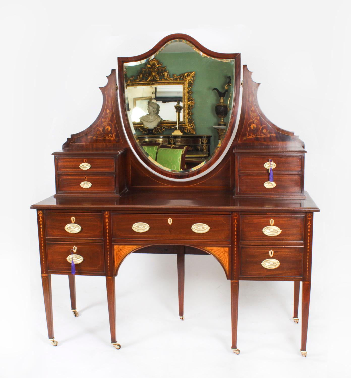 This is a totally fabulous Antique Late Victorian Sheraton Revival Mahogany and Marquetry dressing table, circa 1890 in date.
 
THE BOTANICAL NAME FOR THE MAHOGANY THAT THIS DRESSING TABLE IS MADE OF IS SWIETENIA MACROPHYLLA AND THIS TYPE OF