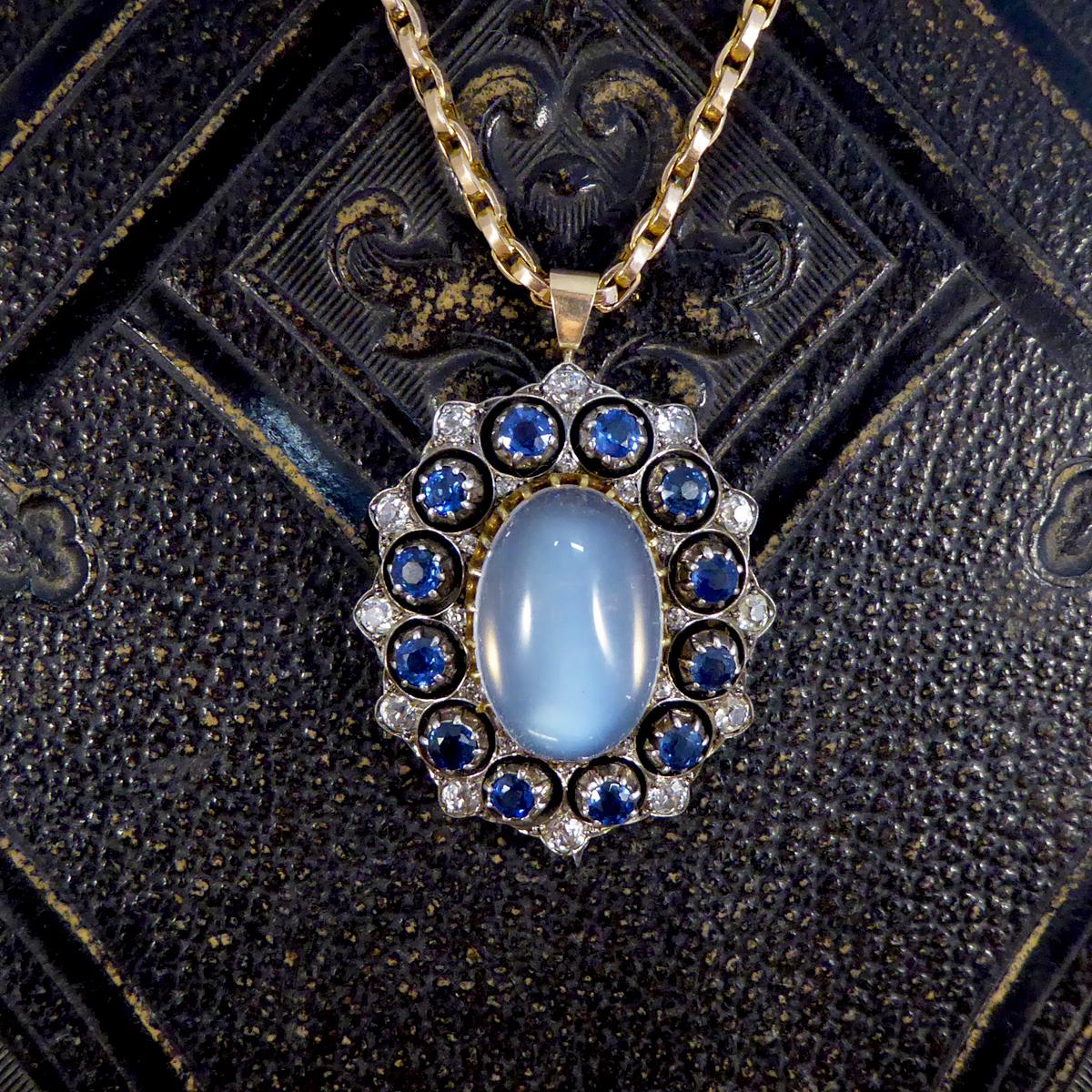 This gorgeous quality antique pendant holds a large claw set moonstone in the centre with a Sapphire and Diamond decorative surround. With a circular surround of 12 round cut Sapphires equally spaced there is a total of 4.20ct all set in a silver