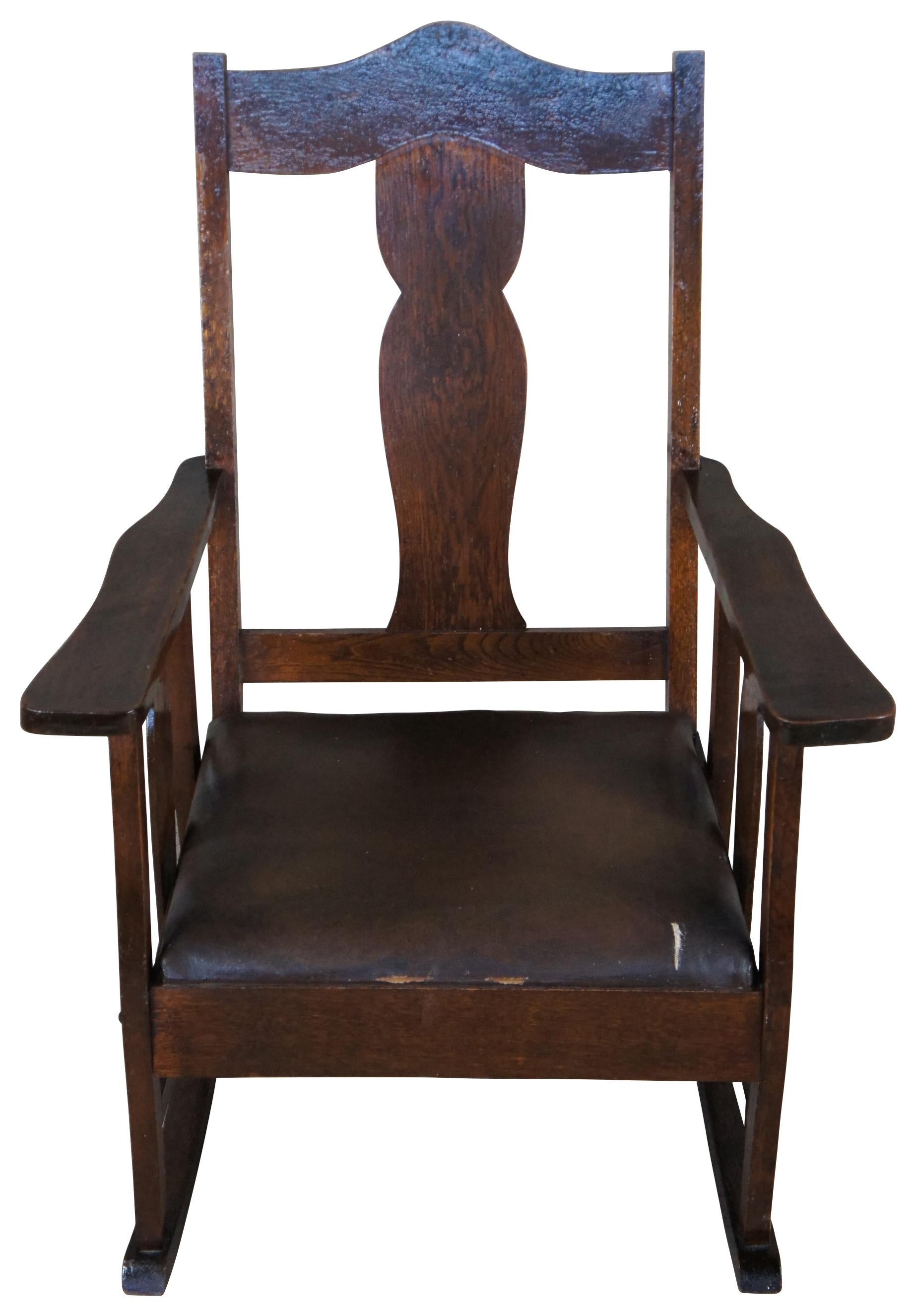 Early 1900s oak rocking chair. Made from oak with vase shaped splat and leather seat.
 