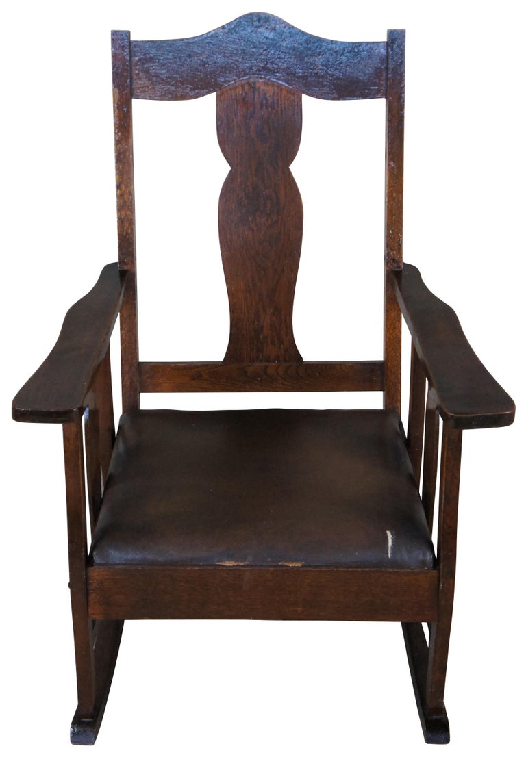 Early 1900s oak rocking chair. Made from oak with vase shaped splat and leather seat.
 
