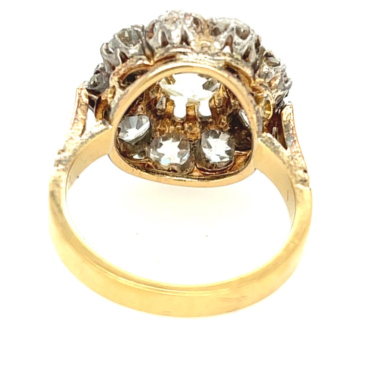An antique Old Mine diamond cluster ring set in 18k gold circa 1890. This cluster is packed with Old Mine cut diamonds with open culets. The center measures to weigh about 1.60 carats and is graded as a O to P color (some warmth to the tone). The