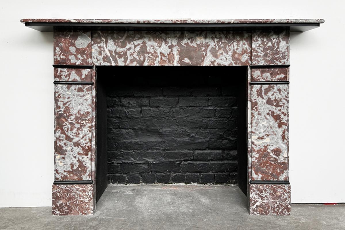 An antique late Victorian fireplace surround in Rouge Royal marble of simple form with Belgian black marble interruptions and undershelf. Circa 1880.

For detailed sizes please see the size diagram in the image gallery.

All our fireplaces are