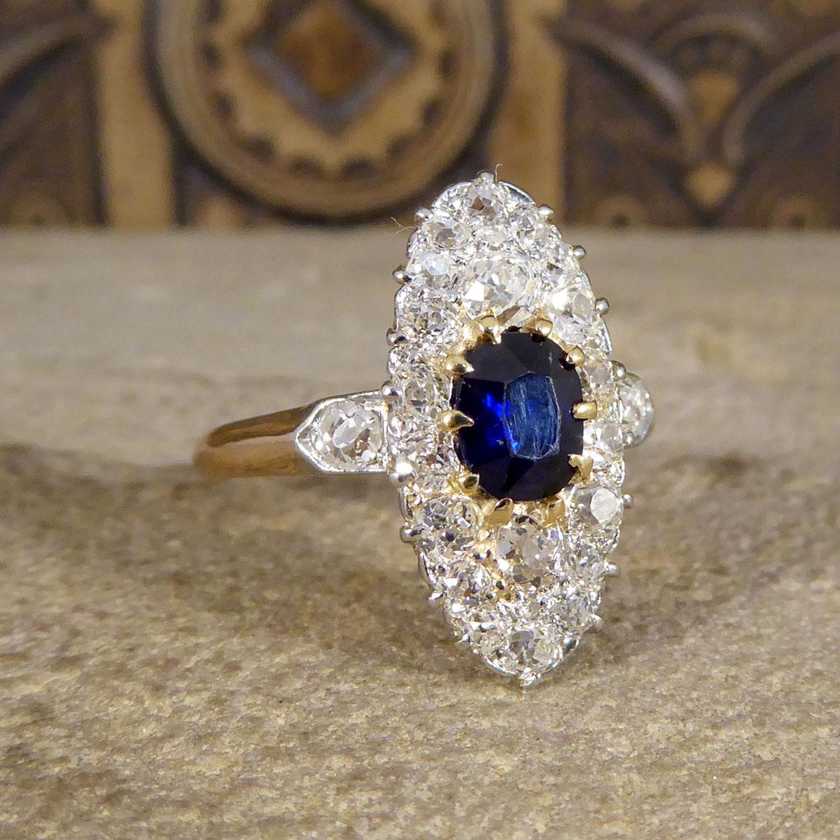 An exquisite antique ring that has been hand crafted in the Late Victorian era. In the centre of this ring sits a 0.55ct Oval Cut Sapphire in a 18ct Yellow Gold claw setting. Surrounding this Sapphires are 22 Old European Cut Diamonds of different
