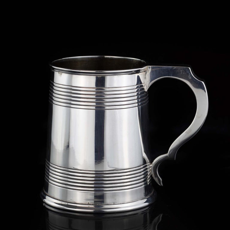 Antique late Victorian sterling silver Christening mug in a tapering cylindrical form with a reeded banded plain body, moulded rim foot and cast bracket style handle. 
Maker : Unidentified ( maker's mark unrecognisable, due to the wear off the mark