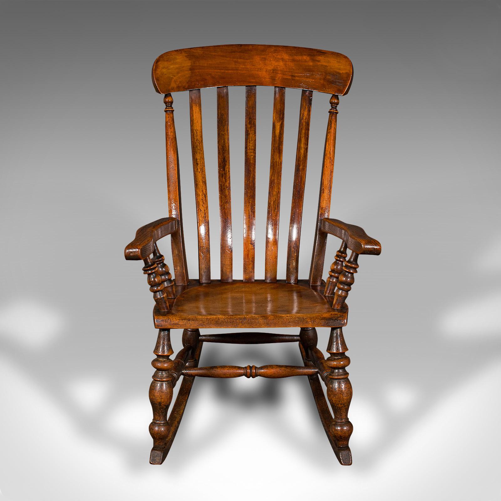 This is an antique lath back rocking chair. An English, elm and beech elbow seat, dating to the late Victorian period, circa 1880.

Superb Victorian craftsmanship to this traditionally appealing rocker
Displays a desirable aged patina and in good