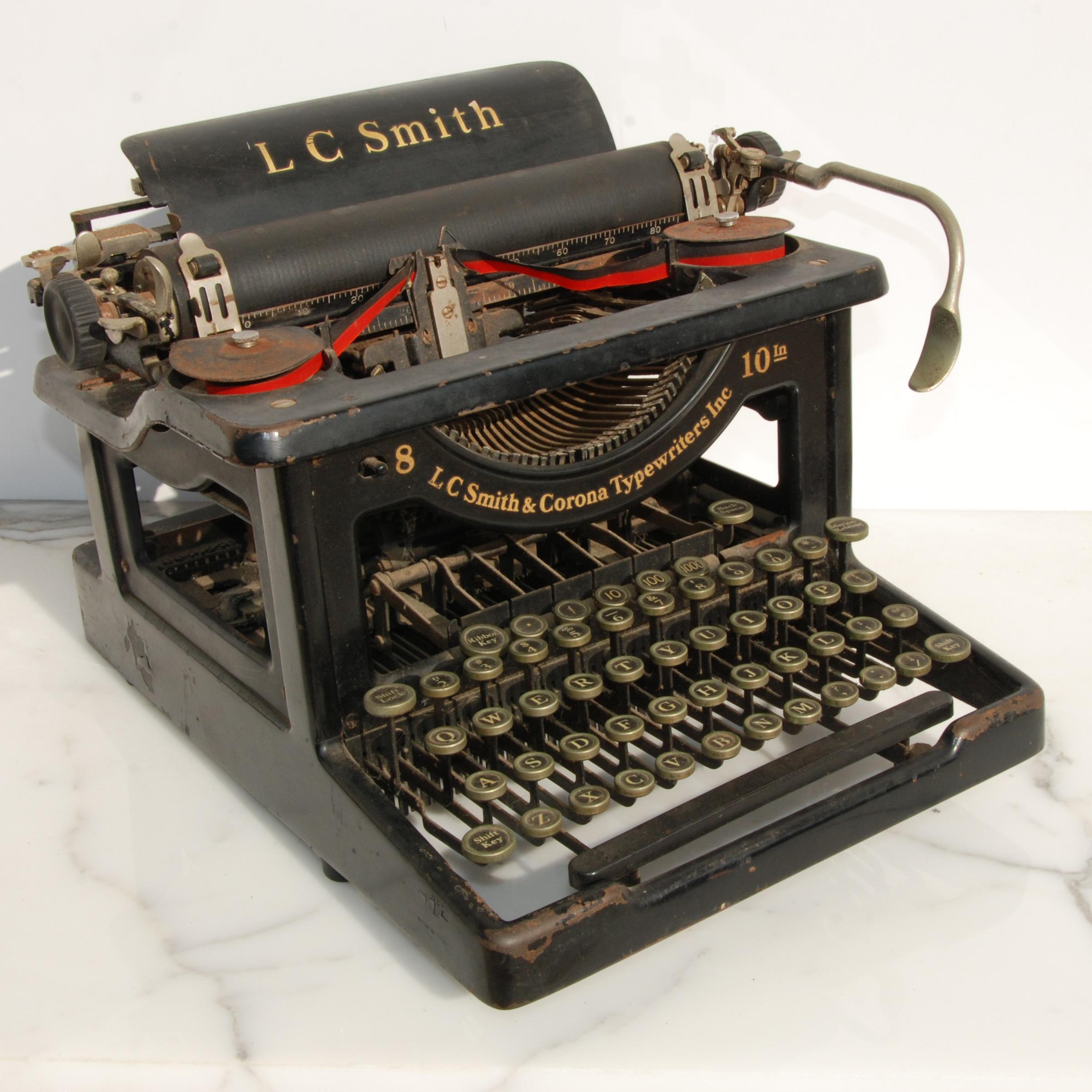 This is an original LC Smith & Corona Typewriter #8 10 with a 10 inch carriage and an open-frame design. The keys are nickel with white face and black numbers. Four rows of keys with a top row of decimals. Keys stick slightly, but can still be typed