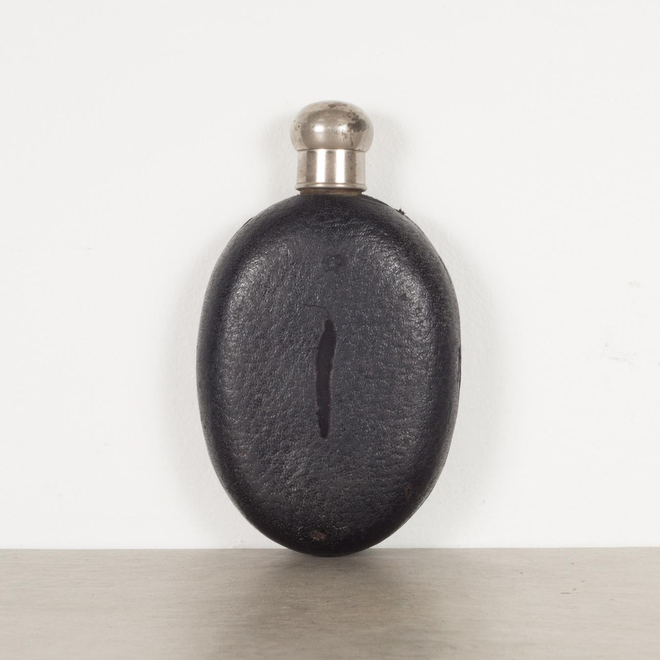 ABOUT

An original leather covered flask with screw top lid, thick glass interior and window on both sides.

 CREATOR Unknown.
 DATE OF MANUFACTURE c.1940.
 MATERIALS AND TECHNIQUES Leather, Glass, Stainless Steel, Cork. 
 CONDITION Good.