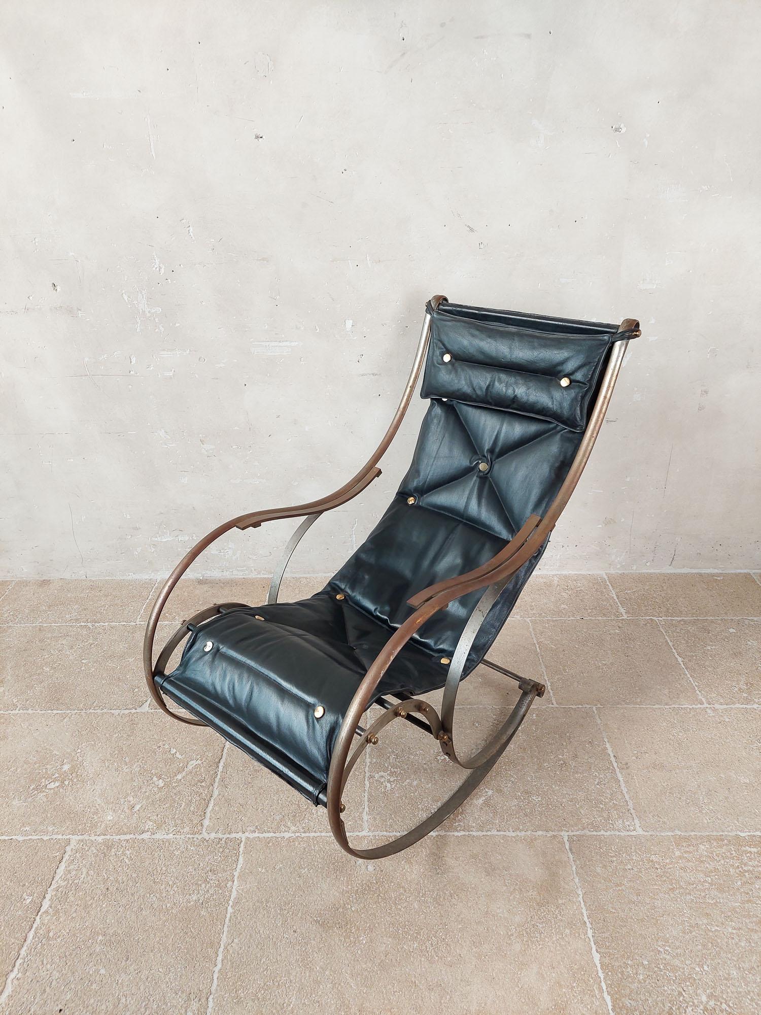 Antique leather and iron rocking chair. An English design classic from around 1850, this rocking chair was designed by the Englishman Peter Cooper for the company R.W. Winfield & Co., Birmingham, England. It has a steel frame with black leather