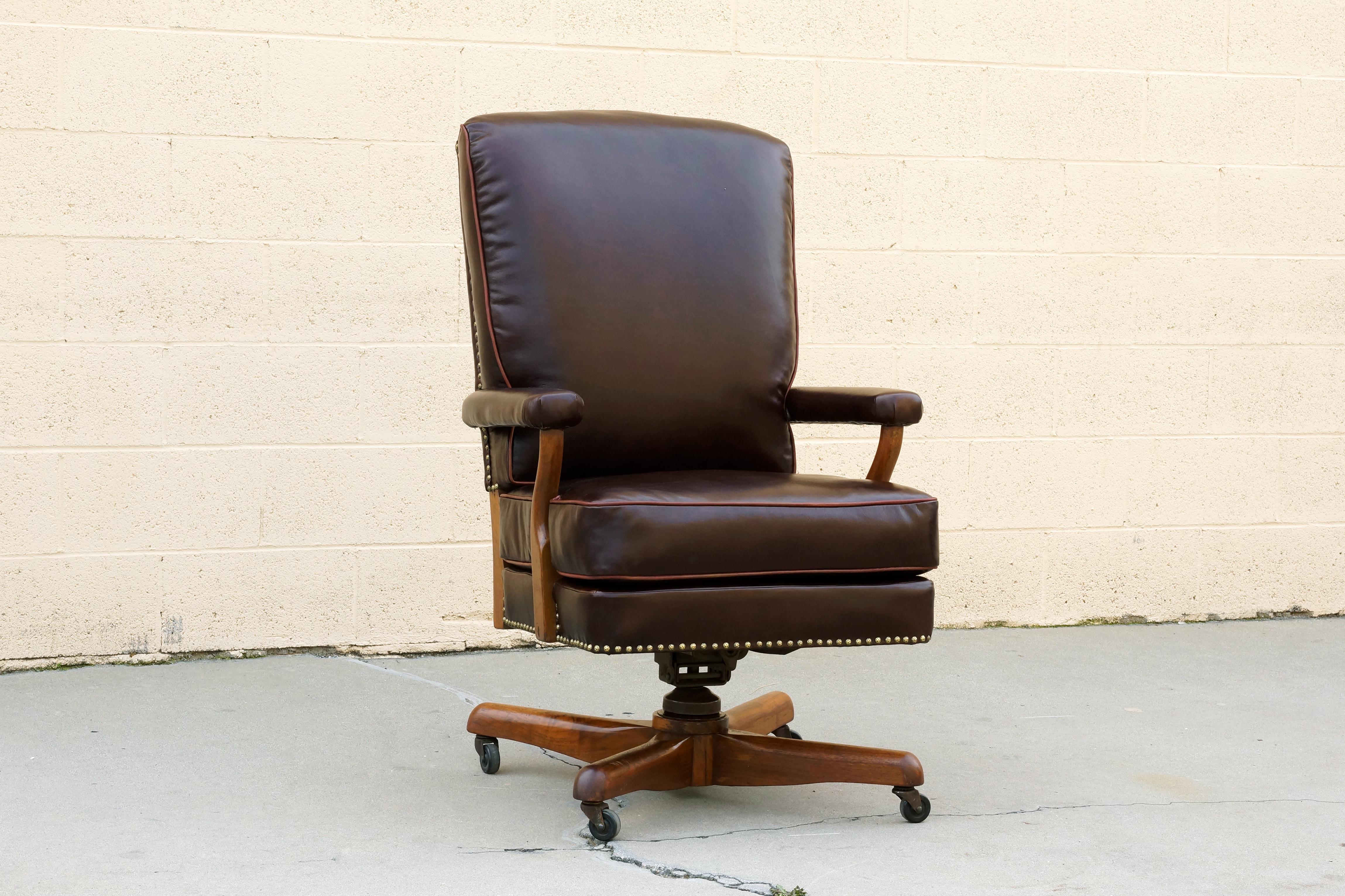Very special leather and walnut oversized armchair, circa 1930s. Newly upholstered in rich brown leather with light brown vinyl piping and hammered upholstery tacks. Thick walnut frame has been lightly reconditioned. Plush and extra comfy.