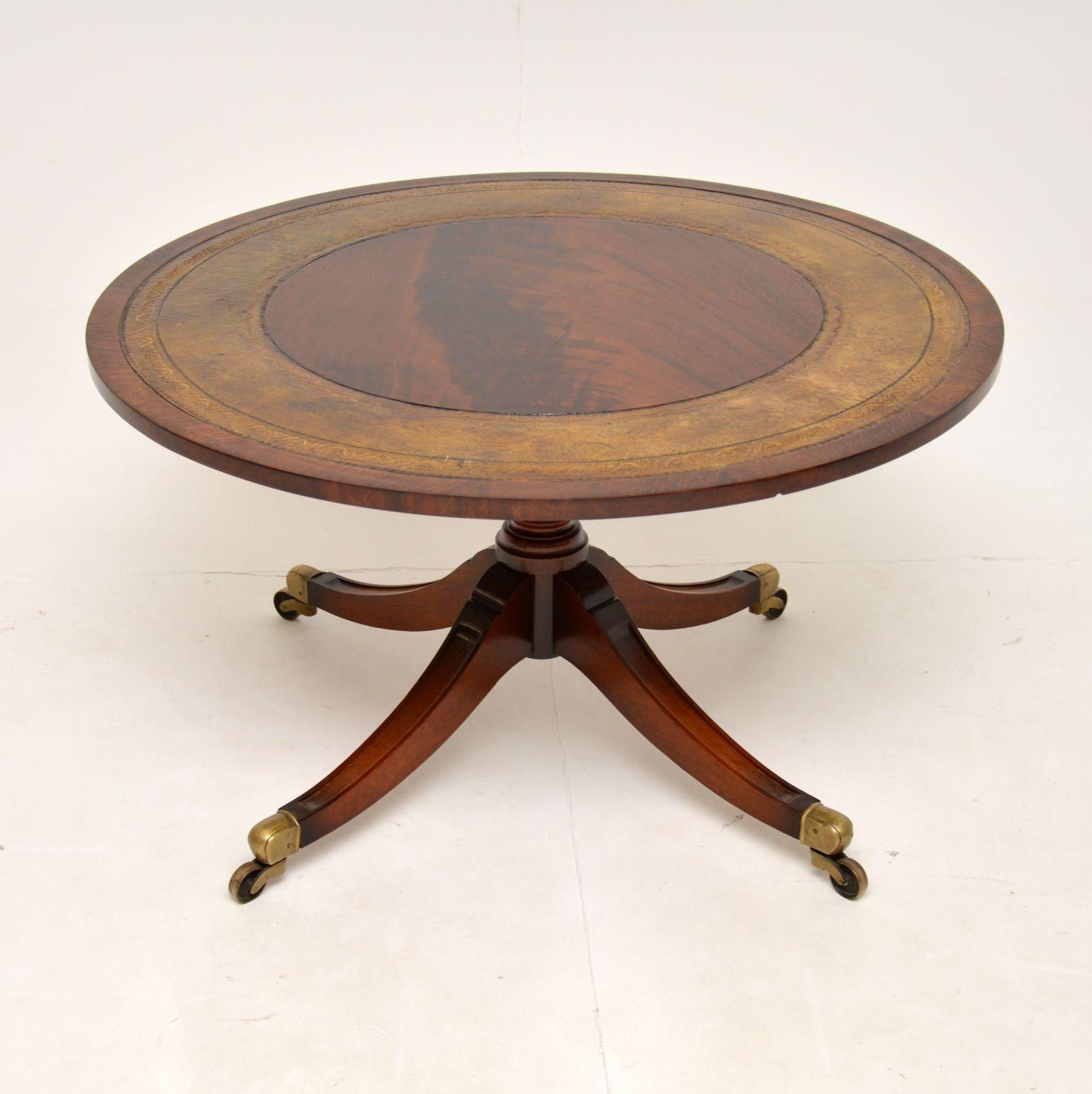 A fantastic antique coffee table in the Regency style. This was made in England & dates from around the 1930’s.

The quality is amazing, this is so well made and is a great size. The circular top has a flame wood centre and edges, with the