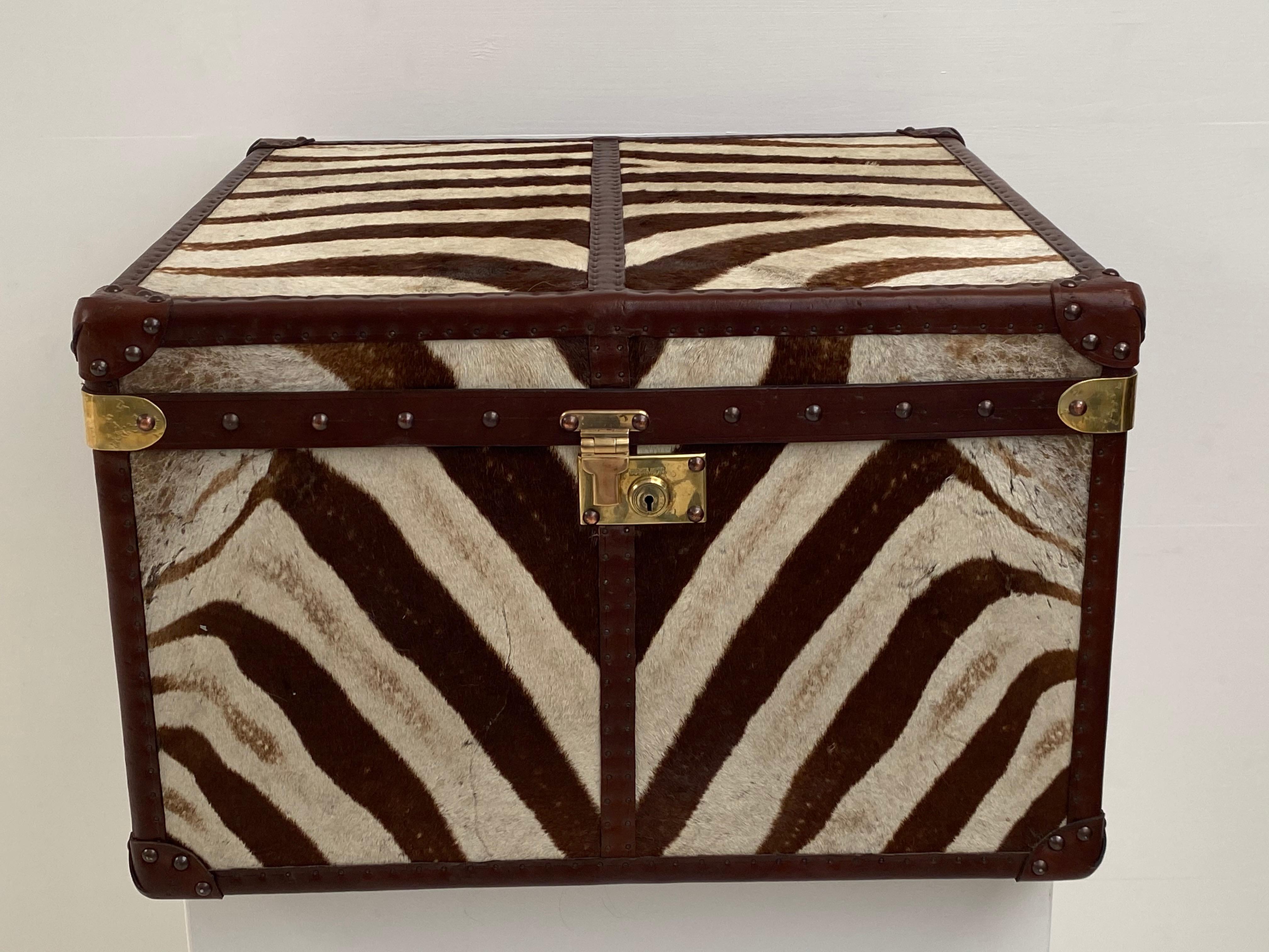 Beautiful antique English brown leather trunk with front and top covered with zebra skin,
nice leather handles and brass corners and lock.