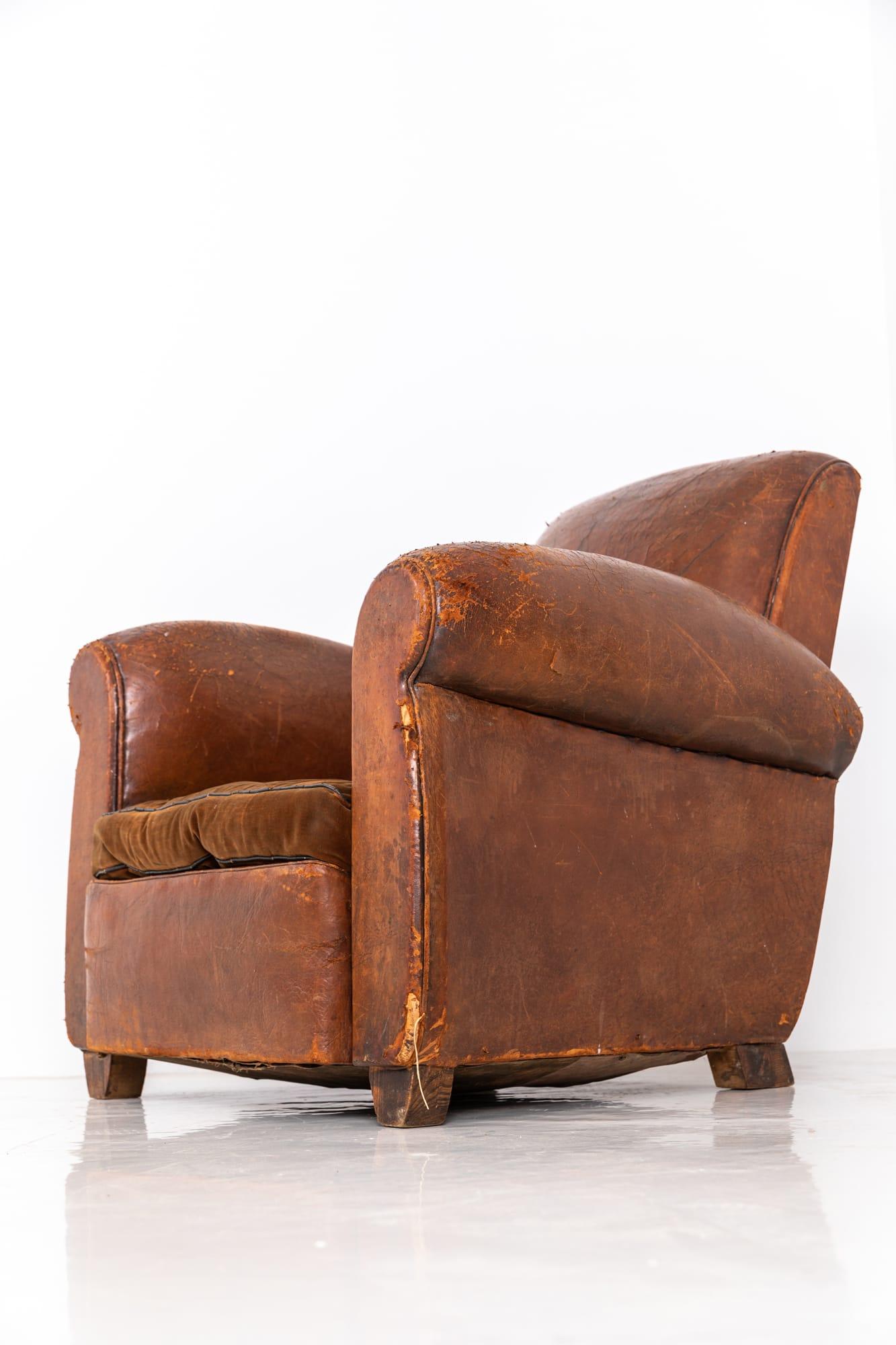 A very attractive art deco leather club chair. c.1930

Really lovely shape and super comfortable. Original leather upholstery which has benefited from a deep clean and feed. Brown velvet squab cushion.