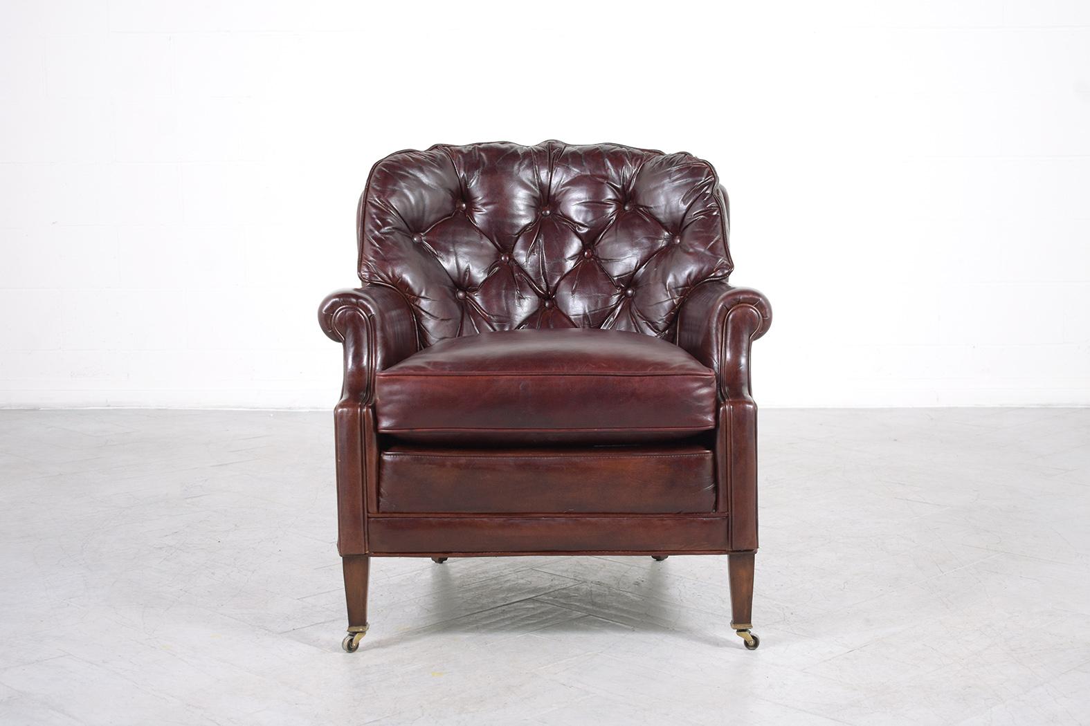 Introducing our extraordinary antique English Chesterfield lounge chair, expertly restored by our team of professional craftsmen. This stunning armchair, with its frame beautifully crafted out of wood and upholstered in fine-quality leather, is in