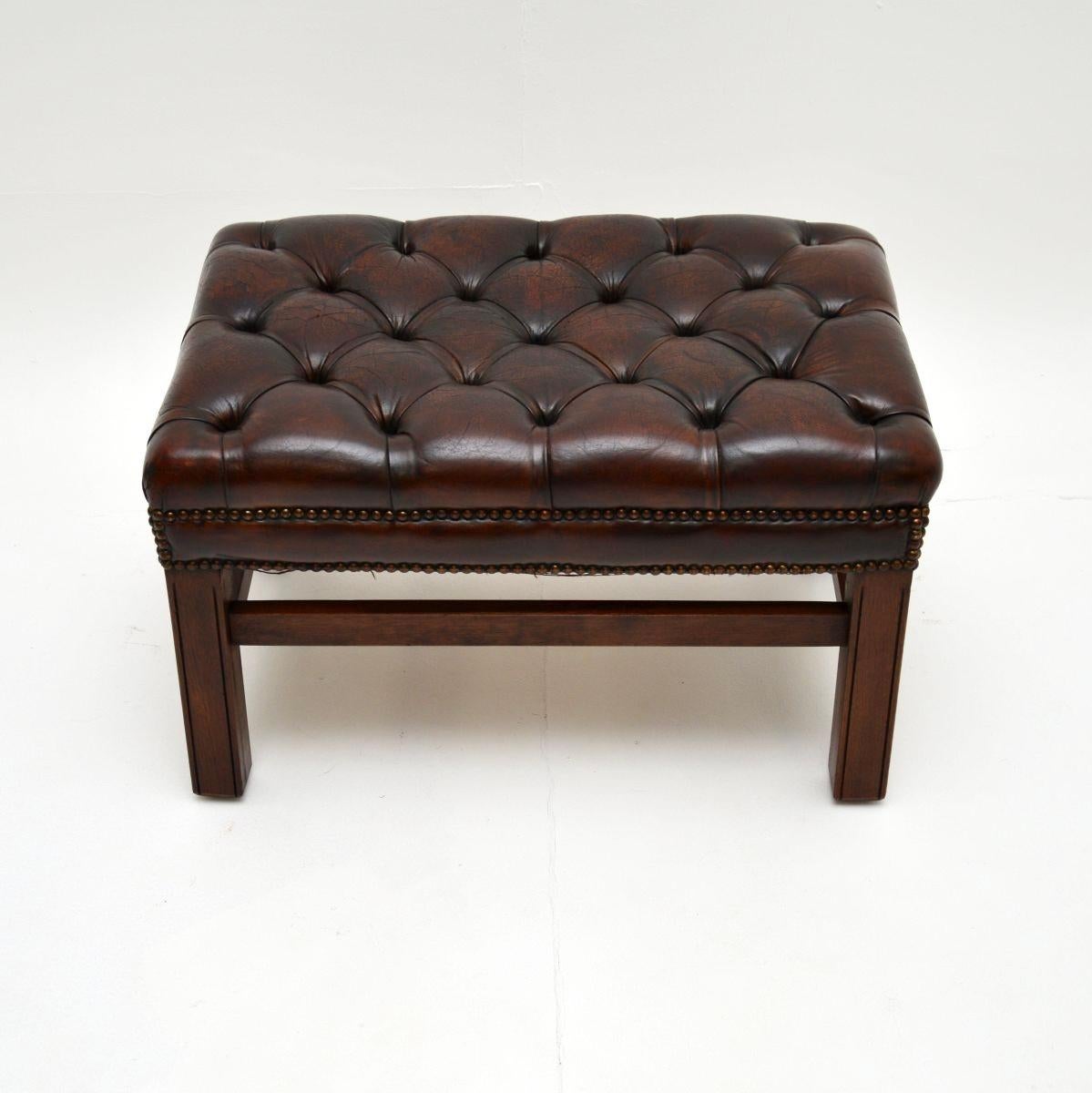 A fantastic antique leather stool. This is in the classic Chippendale style, it was made in England and dates from around the 1920-1930’s period.

It is of super quality and is a very useful size, perfect for use with a leather wing back armchair or