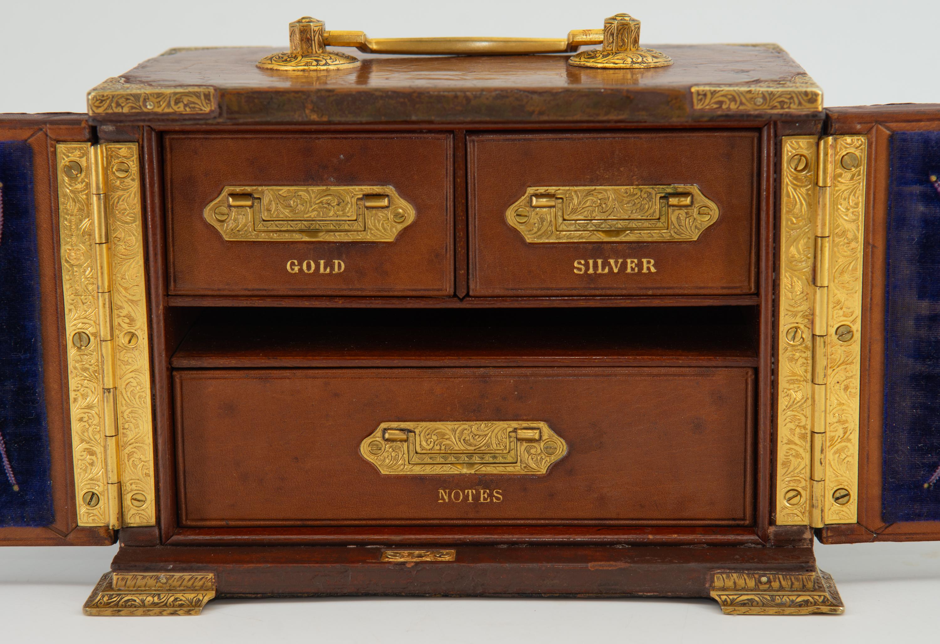 A lovely antique English leather desk top travelling chest with decorative gilt metal mounts to both the exterior and the interior. Bramah lock and key. Circa 1880. 

Delivery included to the UK.

The interior has leather front drawers embossed in