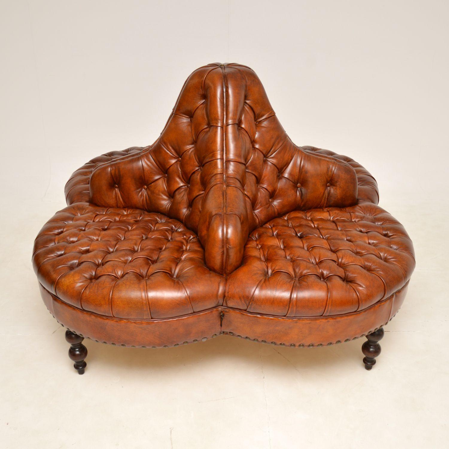 A very large and extremely impressive antique leather four seater conversation sofa in the Victorian style. This was made in England, it dates from around the 1960s.

This would be perfect for a large entry way, library or lounge.

The quality
