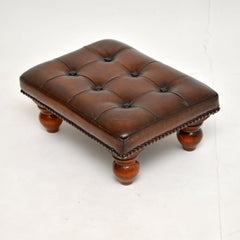 Tabouret de pied en cuir antique
