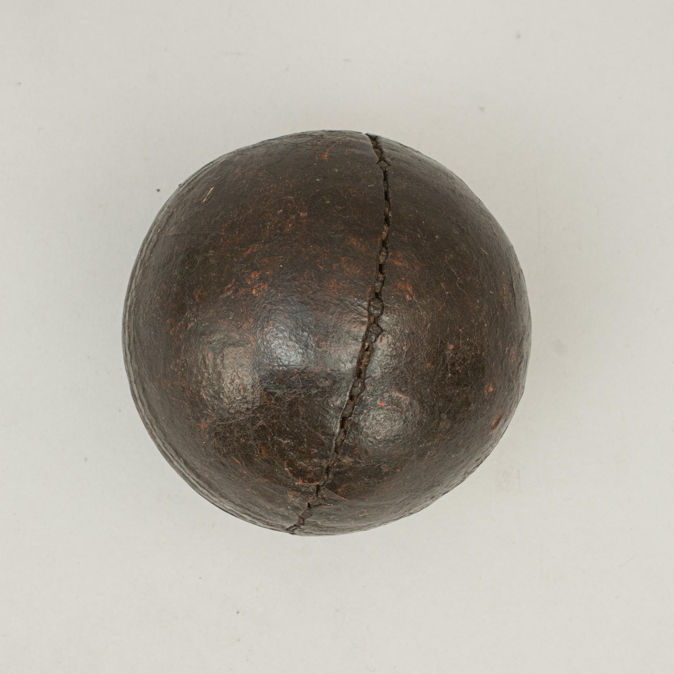 Victorian cricket ball.
A fine brown leather cricket ball. The ball covering is constructed from four pieces of leather. These pieces have two joints that are internally sewn and a main joint that is the 