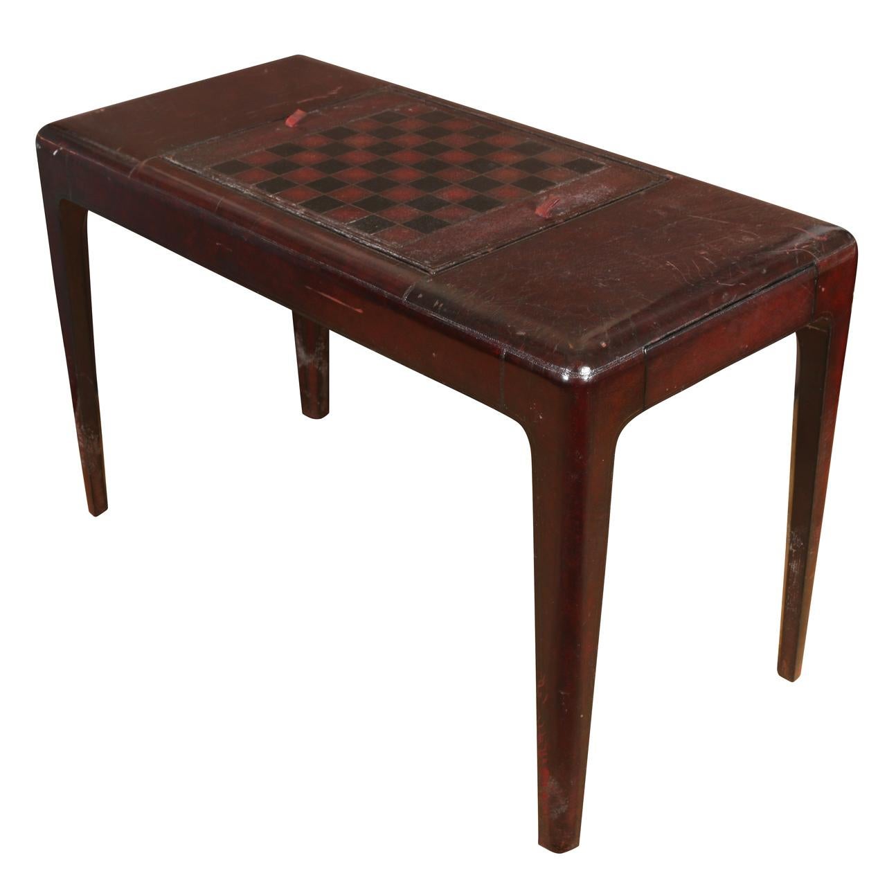 Vintage leather wrapped table in modernist style that can flip between chess board and backgammon table.