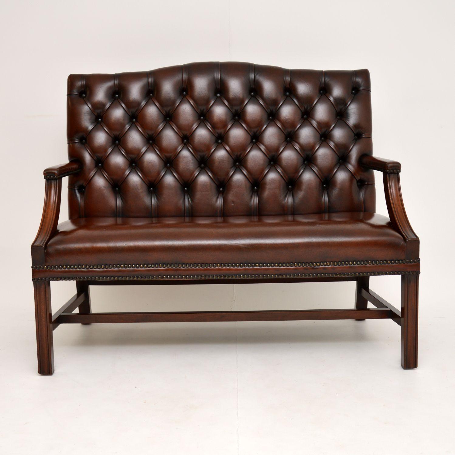 A smart and very well made antique Chippendale style settee, beautifully made from solid mahogany and leather. This dates from circa 1950s.

It’s of top quality and it is quite unusual to see this design as a sofa rather than armchairs. It is