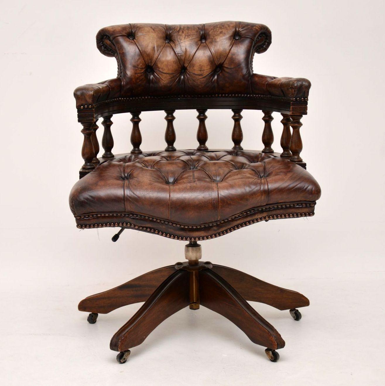 Antique deep buttoned leather mahogany desk chair in good original condition & full of character. The leather has a fabulous original look & a wonderful color, with natural fading & distressing. This desk chair is very comfortable too because of its