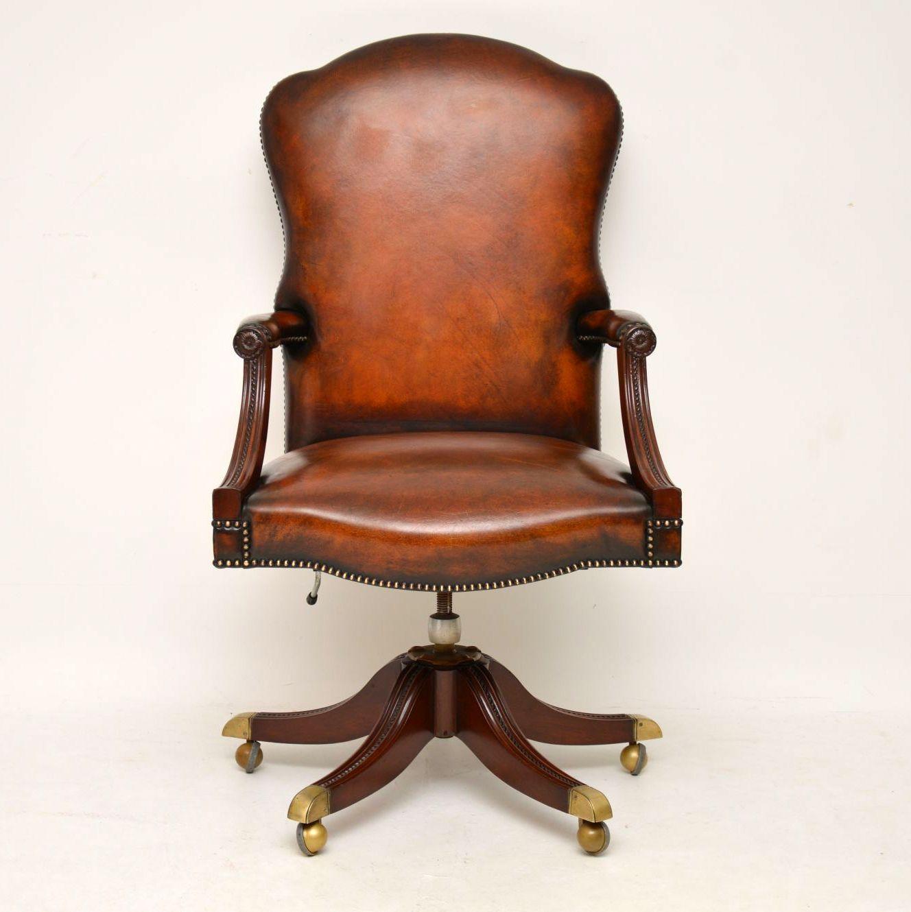 Very comfortable antique Georgian style leather swivel desk armchair in good condition & with plenty of back support. The leather is original & in excellent condition with loads of character. This chair has a shaped high back & leather padded arms.