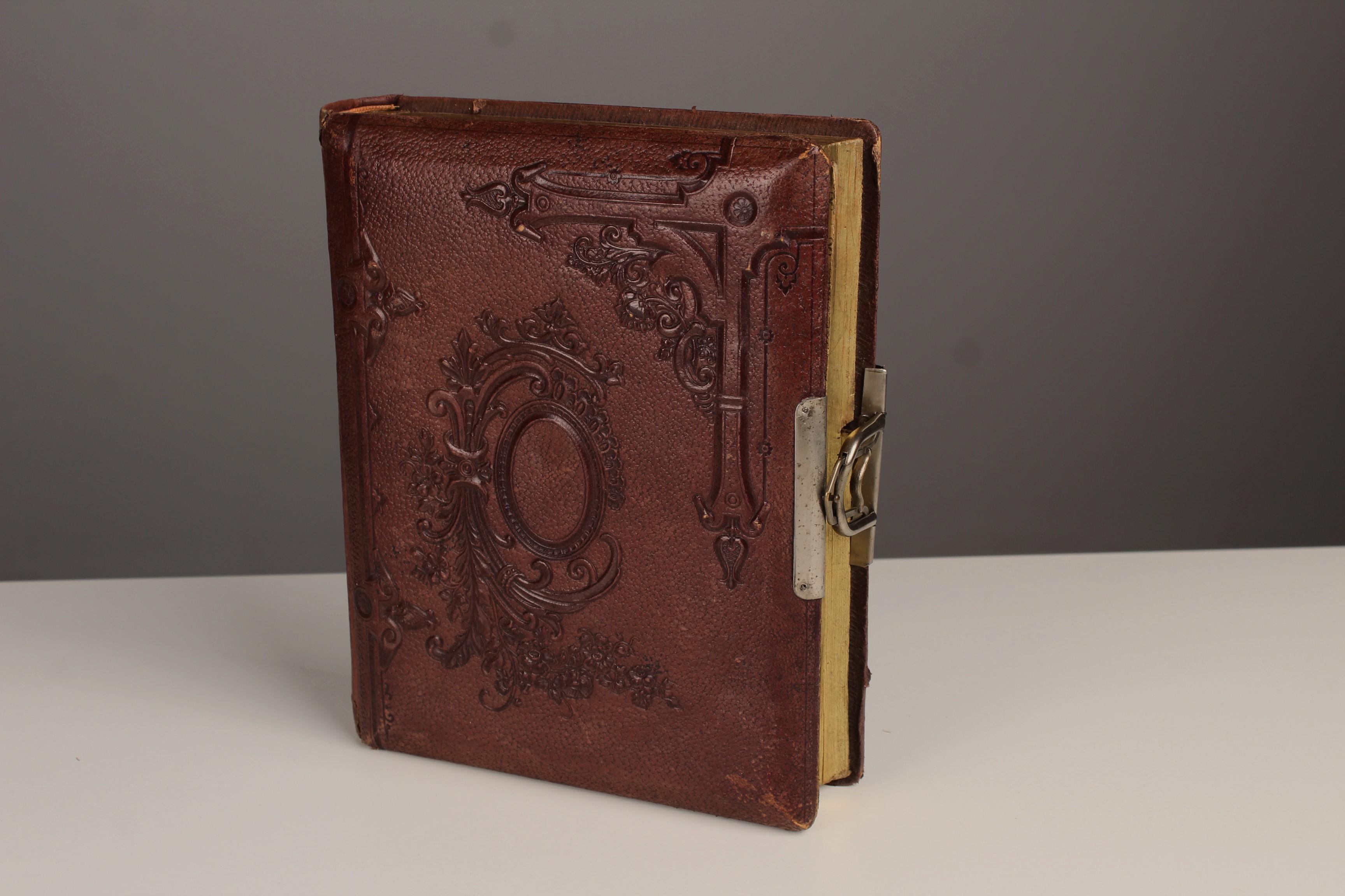 Unique antique photo album with a music box, which starts to play when opening the closure.





