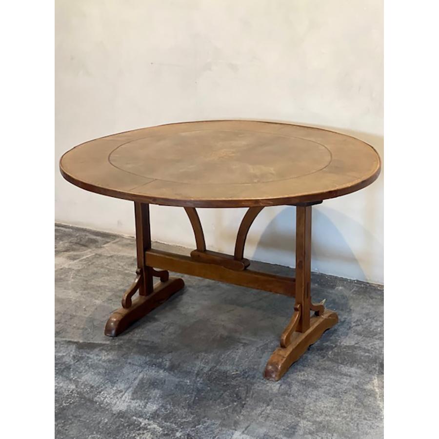 Antique leather round tilt-top wine table, embossed pattern w/ gold accent on top. greenish brown coloration. 

Item #: FR-0231

Dimensions: 45